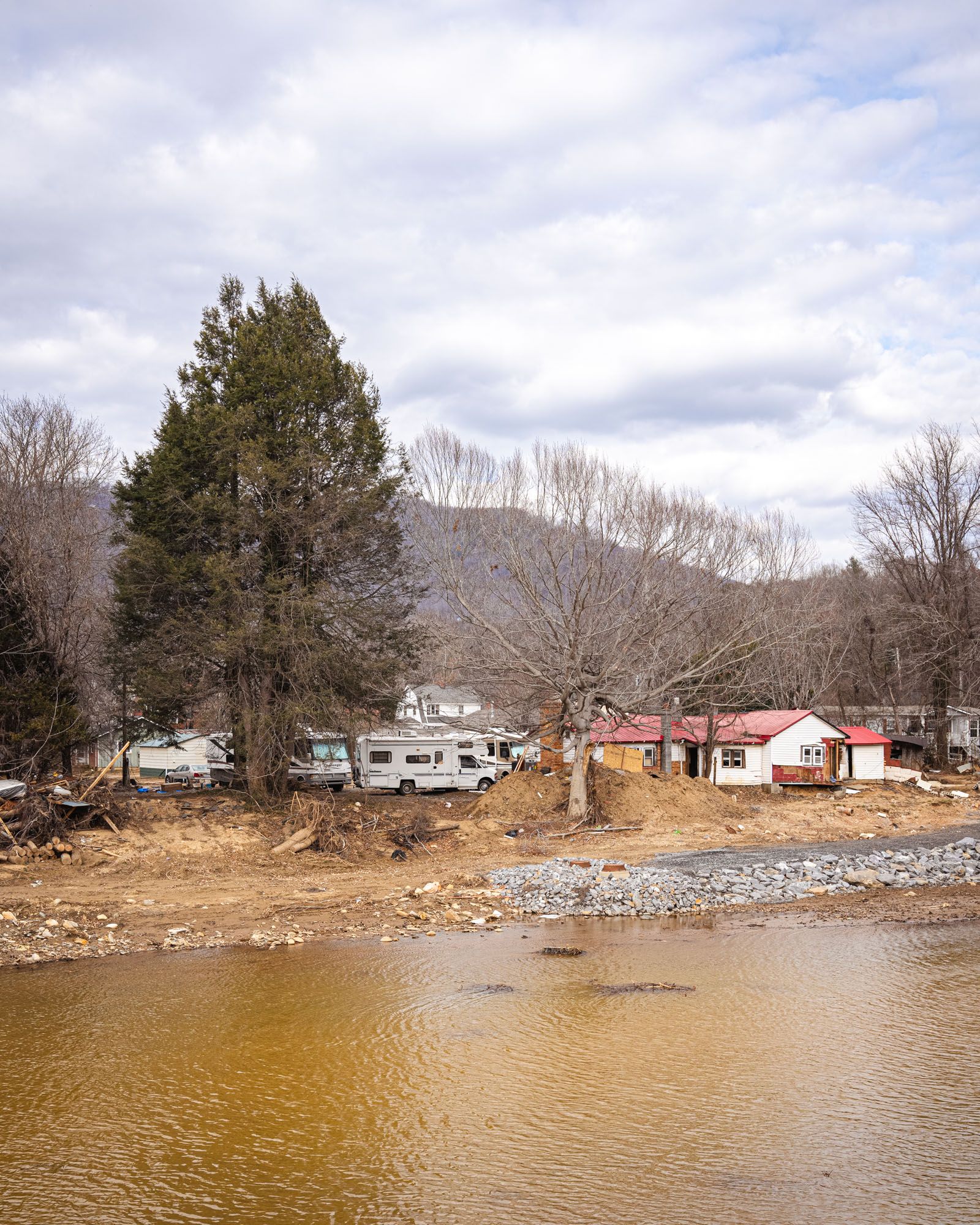 A view of a neighborhood and the mountains by the river in Swannanoa Valley.