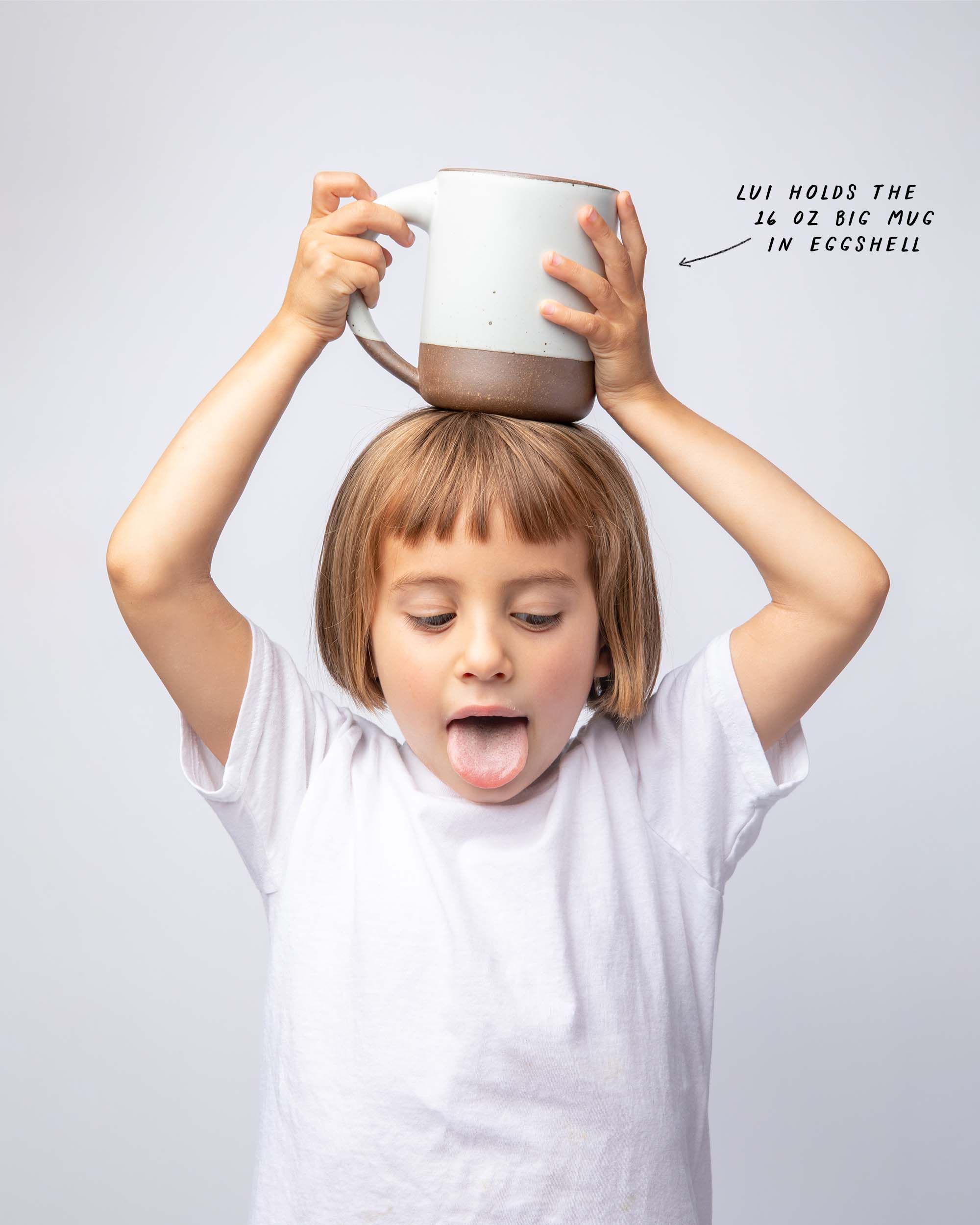 Lui holds the 16 oz Big Mug in Eggshell, on top of her head.