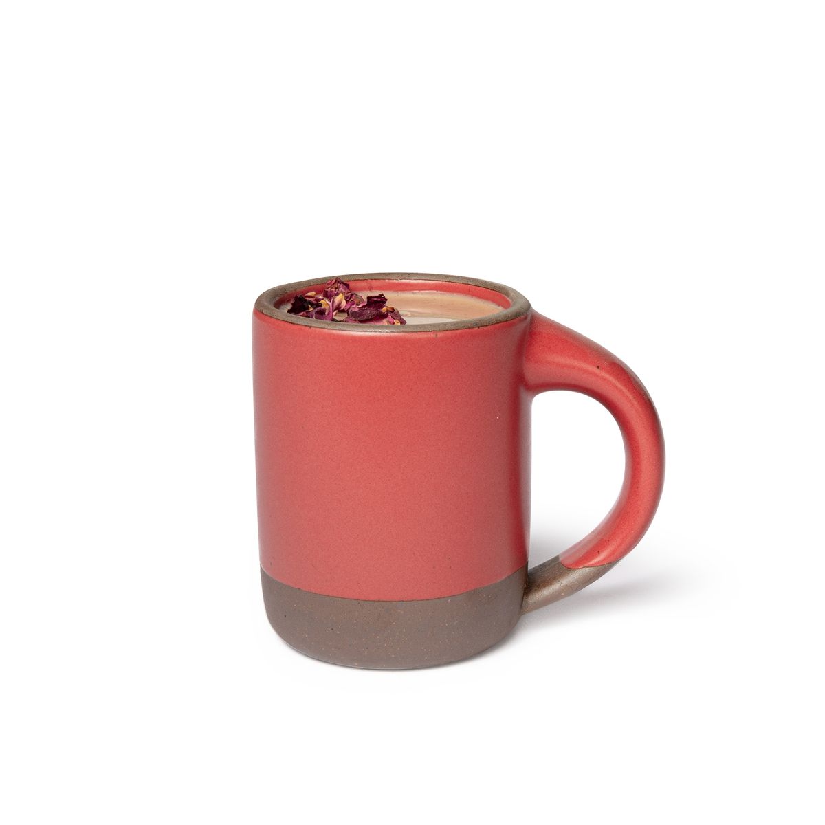 A medium sized ceramic mug with handle in a bold red color featuring iron speckles and unglazed rim and bottom base, filled with hot chocolate