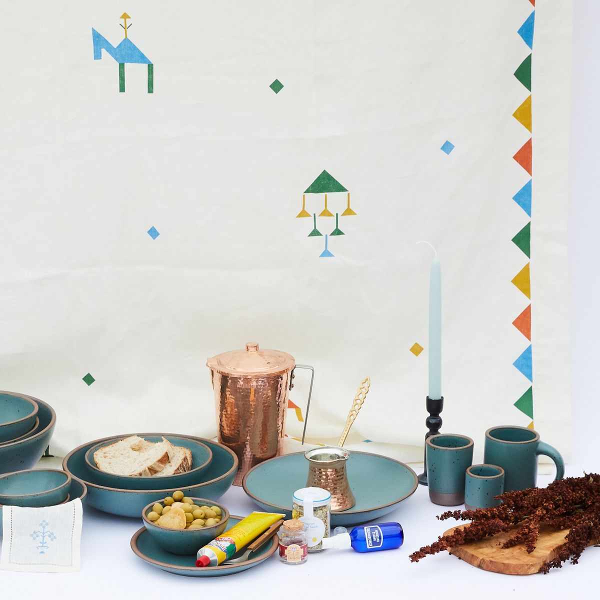 White tablecloth with festival images hanging behind a feast