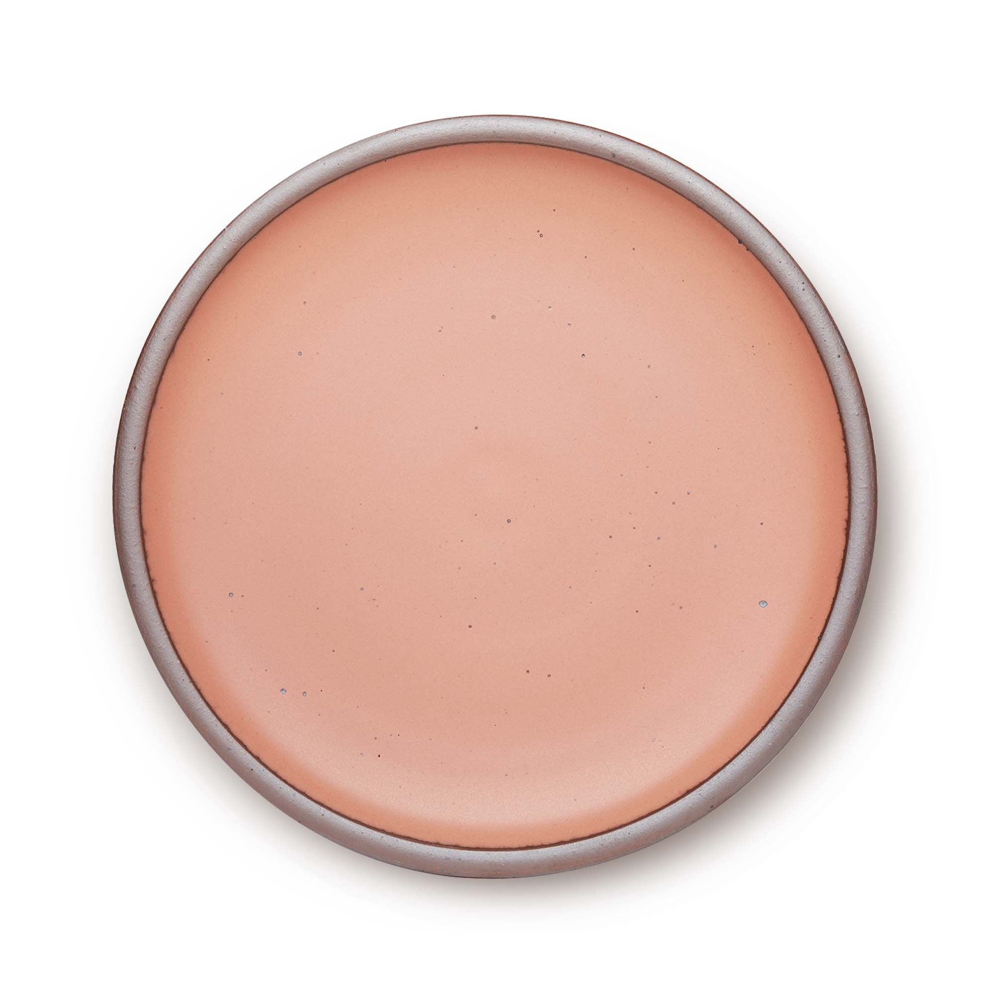 A large ceramic platter in a light warm peach color featuring iron speckles and an unglazed rim.