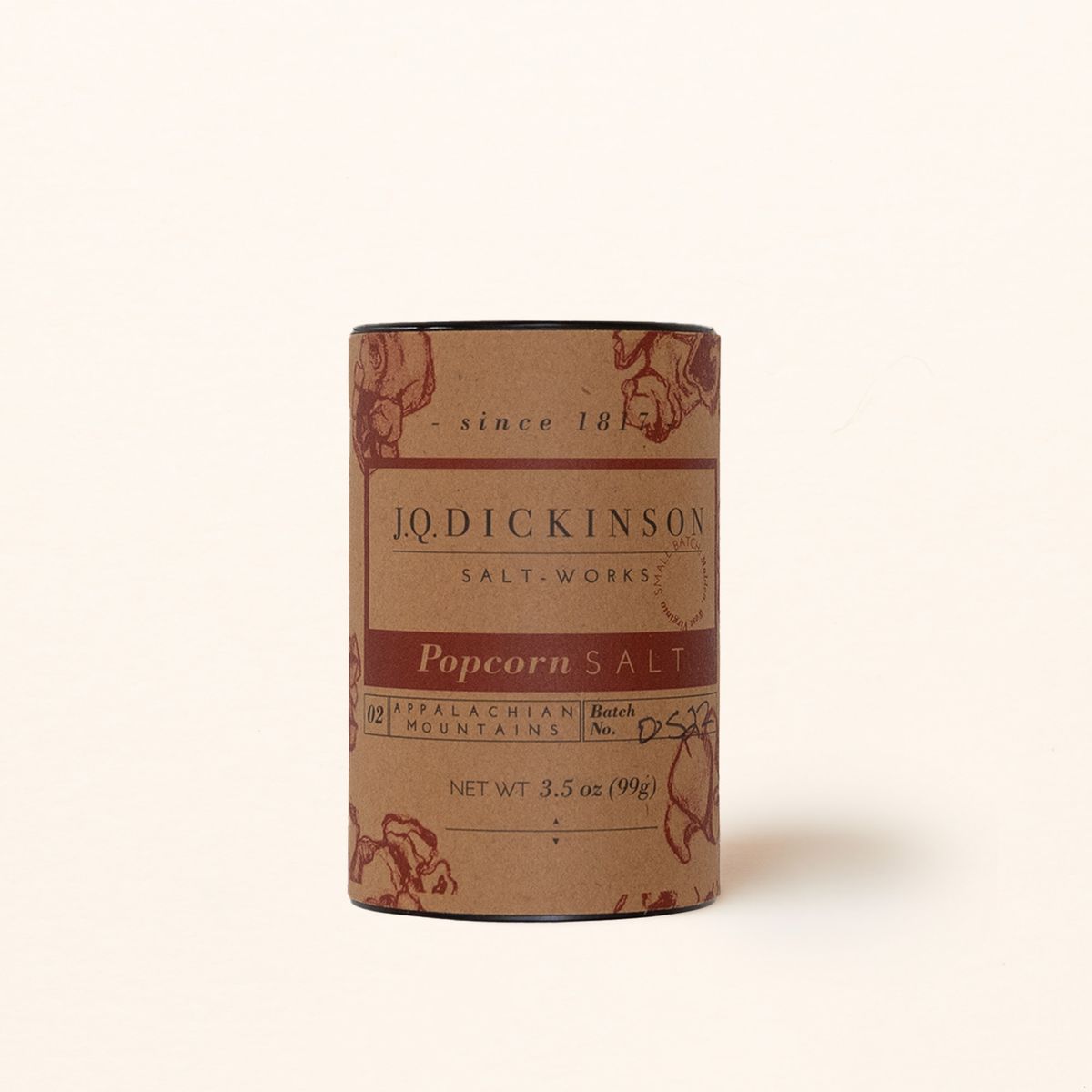 A kraft brown cylinder canister with a label that reads J.Q. Dickinson Salt Works Popcorn Salt.