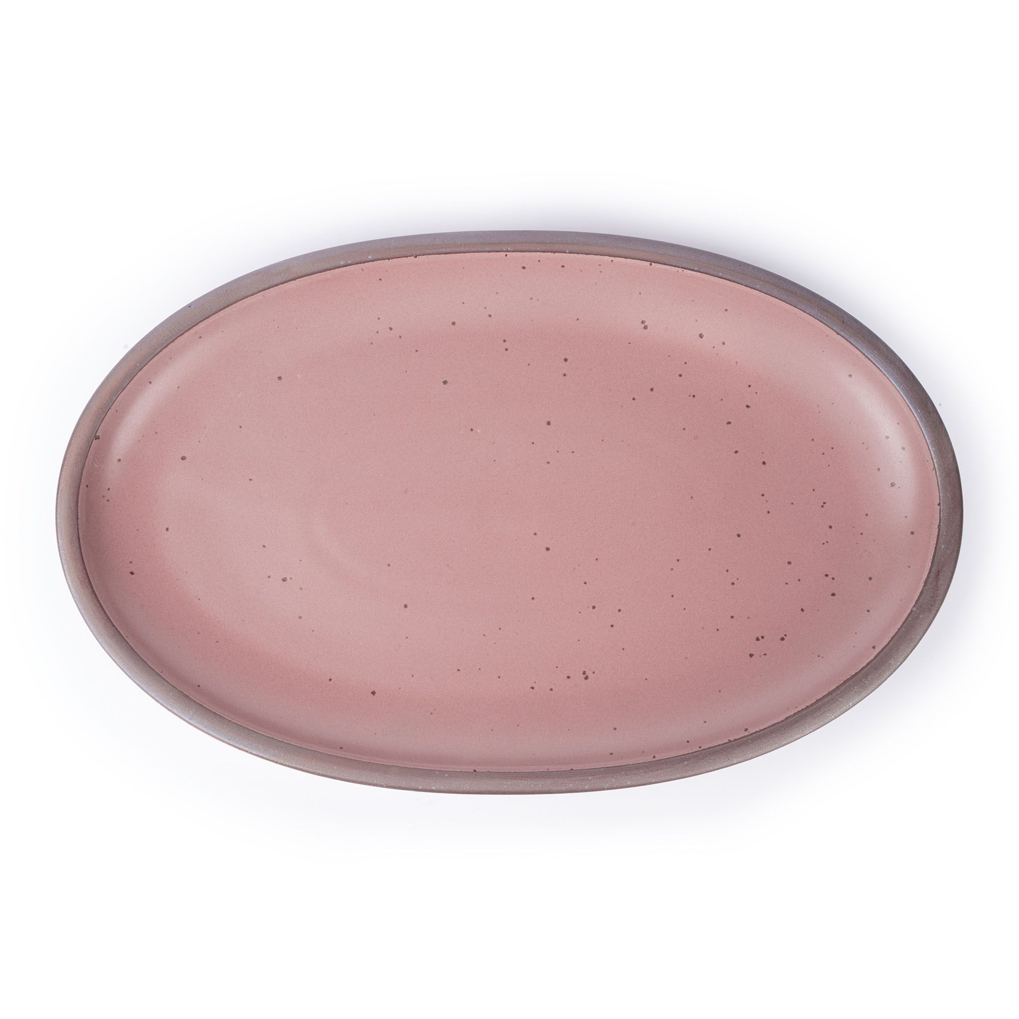 A large oval ceramic platter in a dusty mauve pink color featuring iron speckles and an unglazed rim