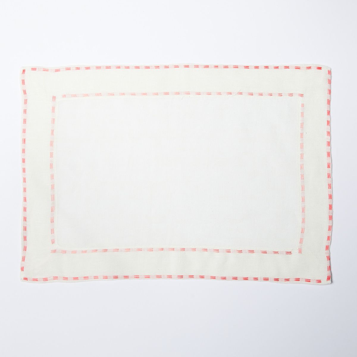 White placemat with coral border