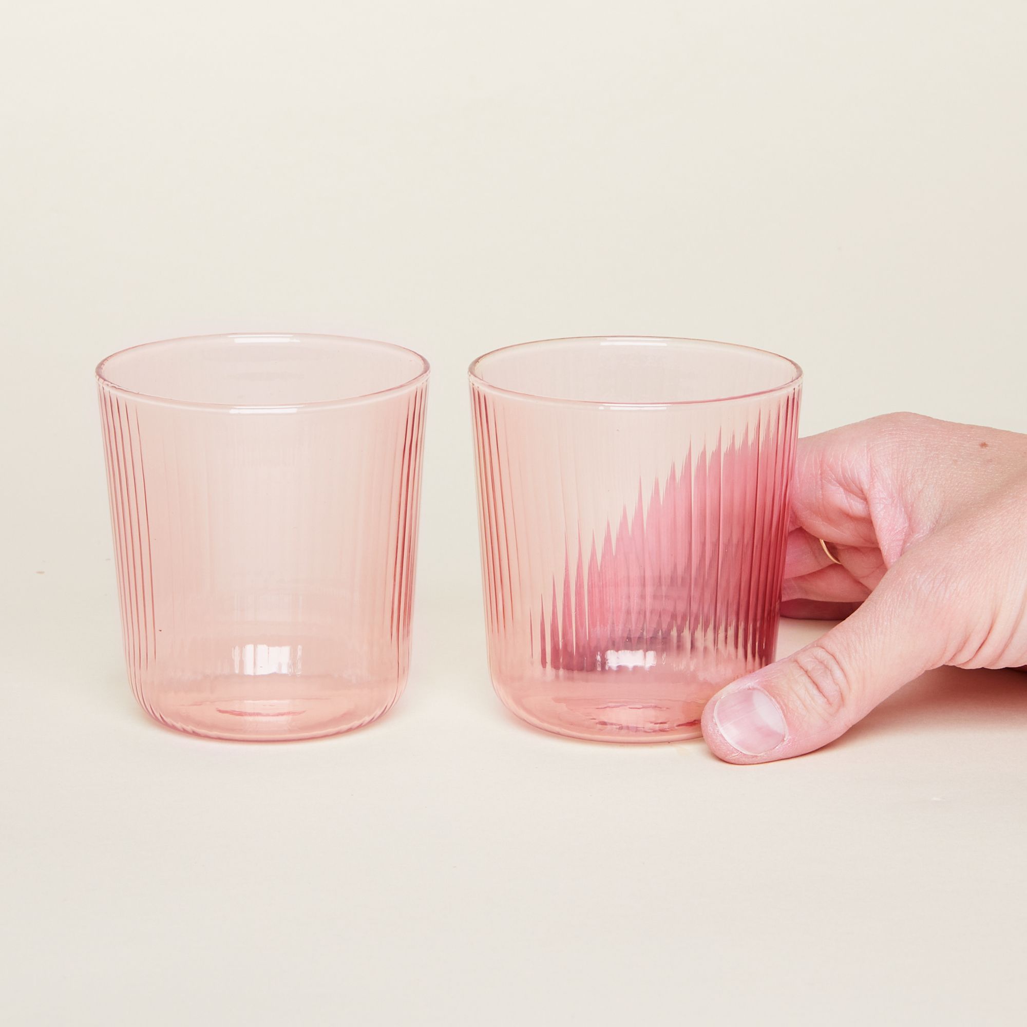 Stemless wine glasses with vertical grooves in three slightly translucent and sensational colors: sand, citrine green and hot pink.