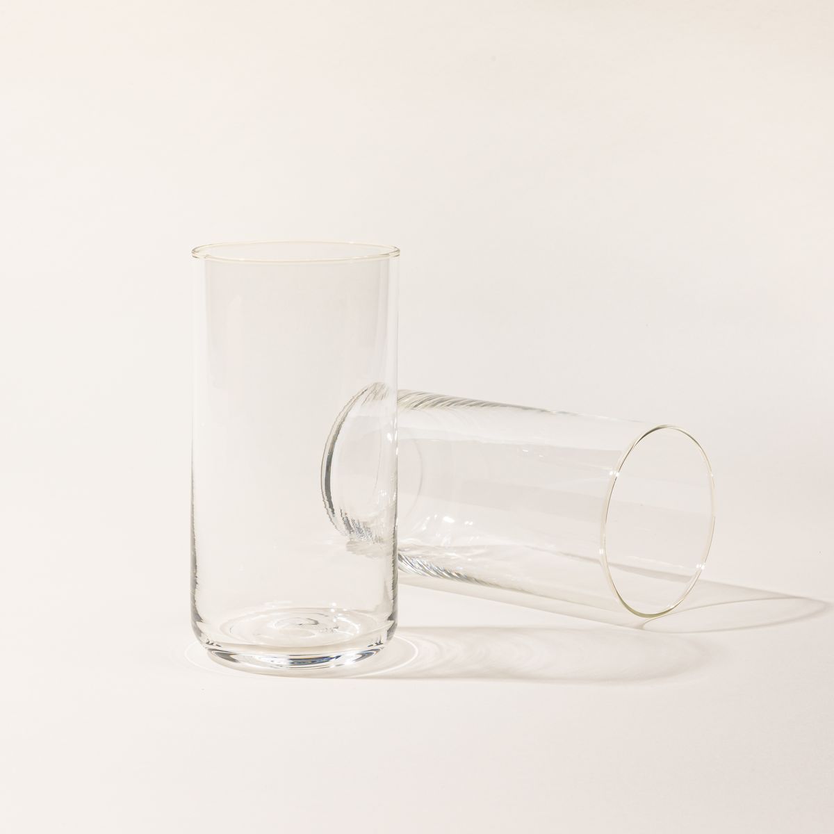 Two straight walled clear tall glasses