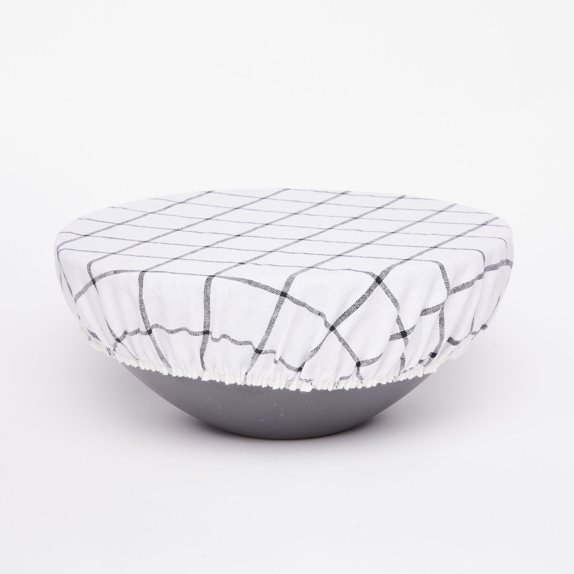 Mixing bowl with white linen bowl cover with dark gray grid design