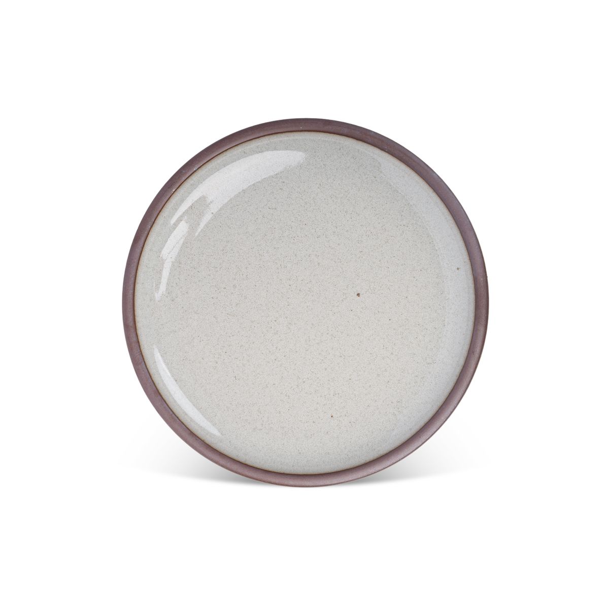 A dinner sized ceramic plate in a reflective icy off-white color featuring iron speckles and an unglazed rim