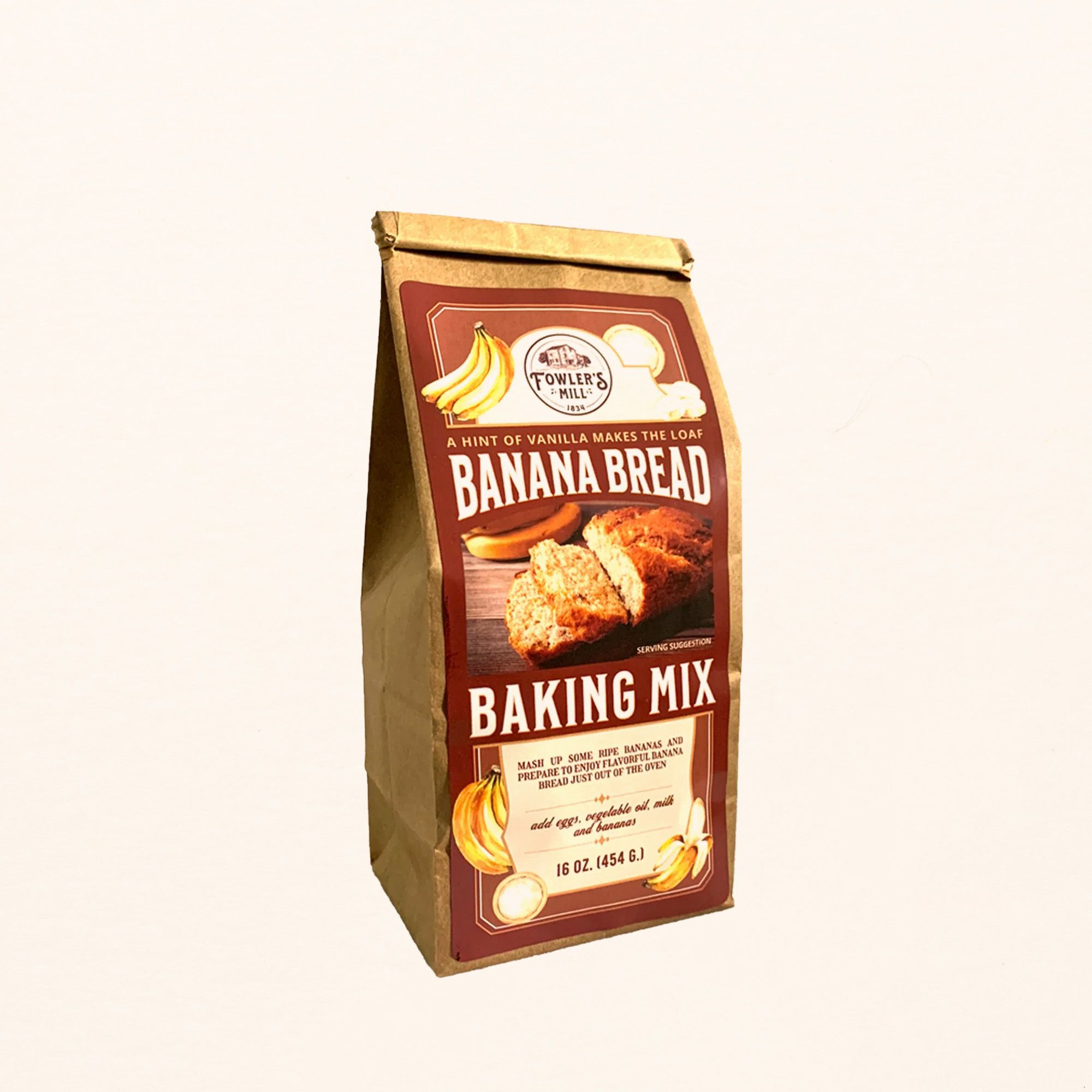 A kraft bag with a maroon label on the front that reads "Banana Bread Baking Mix' with a photo of sliced banana bread on it.