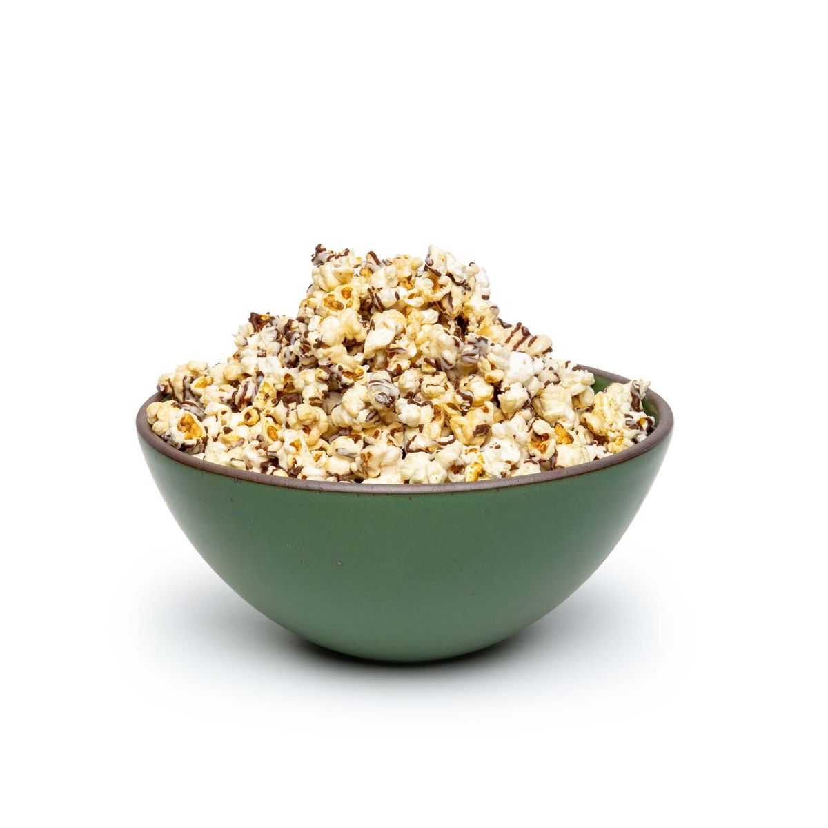 A large rounded ceramic bowl in a deep, verdant green color featuring iron speckles and an unglazed rim, filled with popcorn