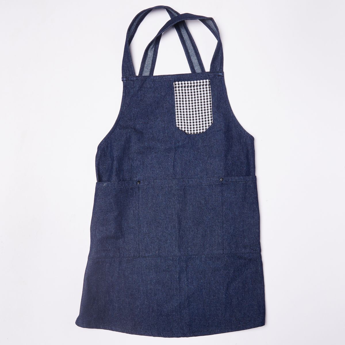 Denim blue kids criss cross apron with a little pocket on the top right in a gingham fabric