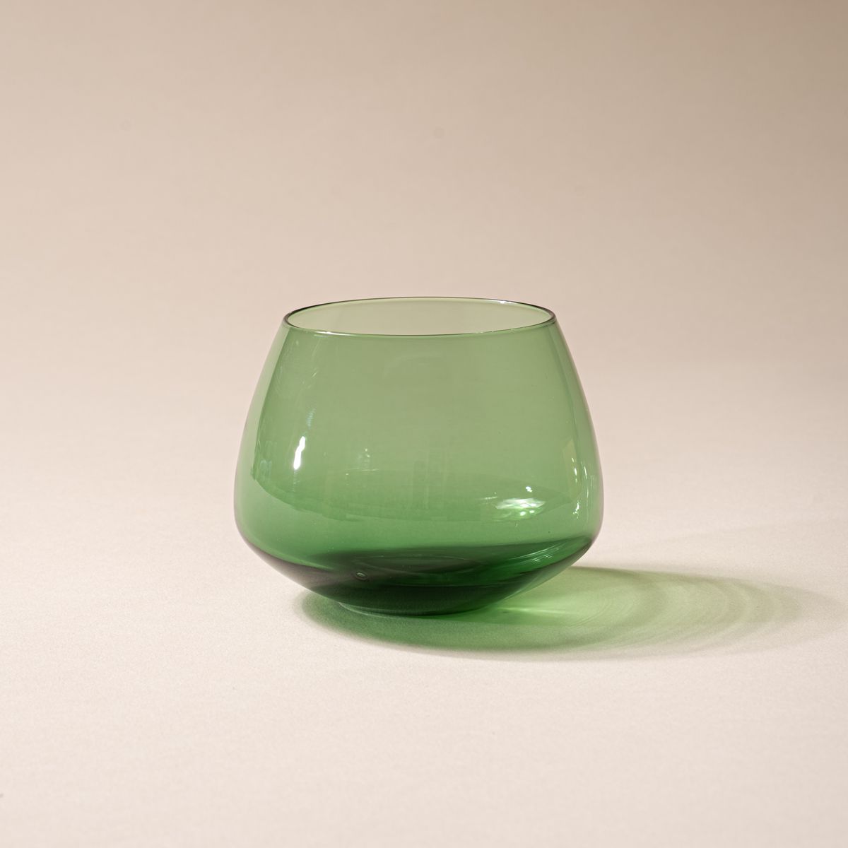 Green glass whiskey snifter with a rounded base