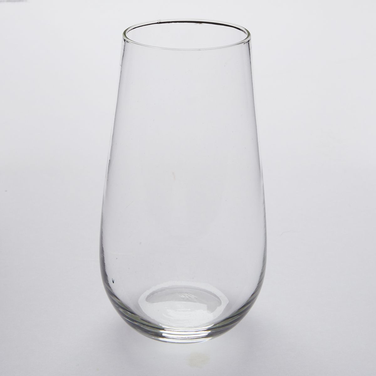 One clear stemless champagne glasses that taper slightly toward the rim