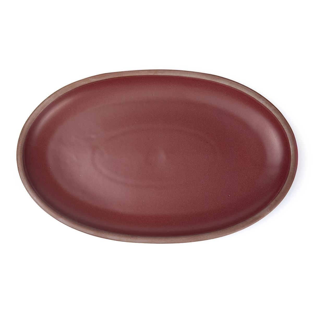 A large oval ceramic platter in a plum color featuring iron speckles and an unglazed rim