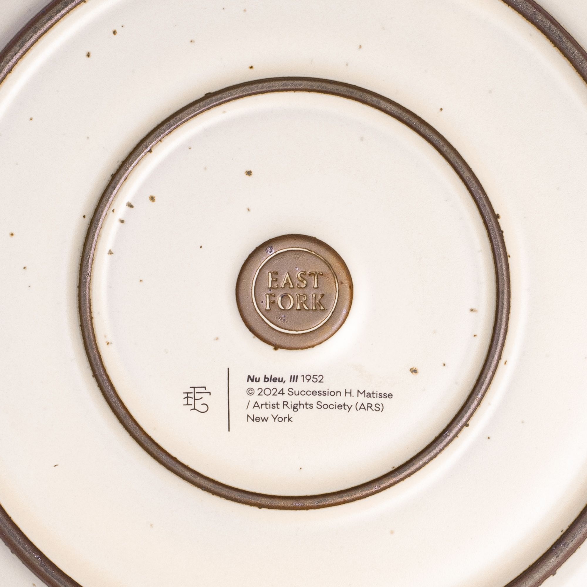 The back of the Dinner Platter with an East Fork stamp with a small decal of information about the artwork.