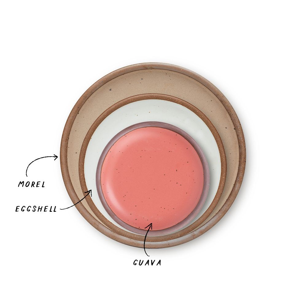 A stack of 3 plates in Dinner, Side, and Cake sizes in a pale warm brown, cool white and watermelon pink colors.