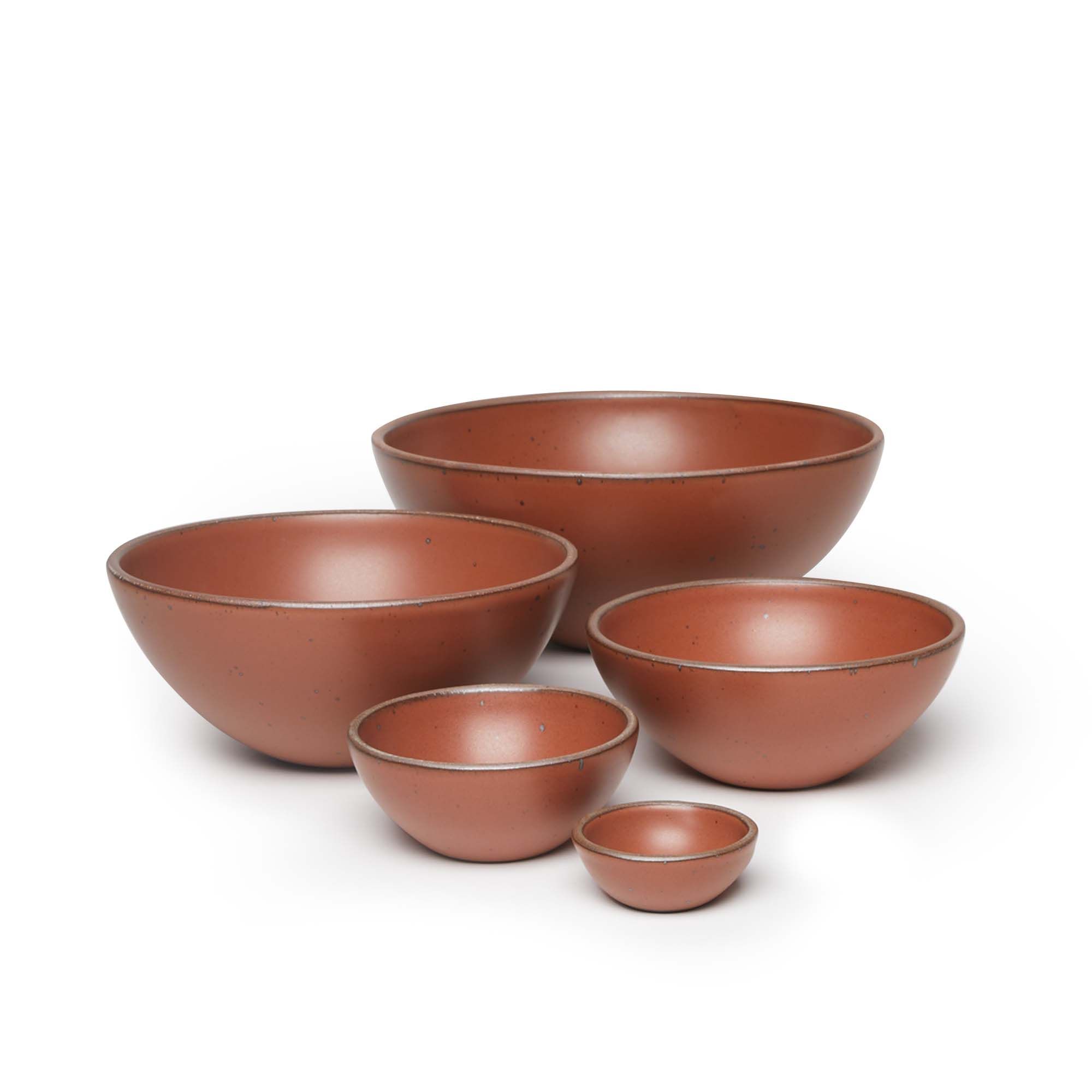 A bitty bowl, ice cream bowl, soup bowl, popcorn bowl, and mixing bowl paired together in a cool burnt terracotta color featuring iron speckles