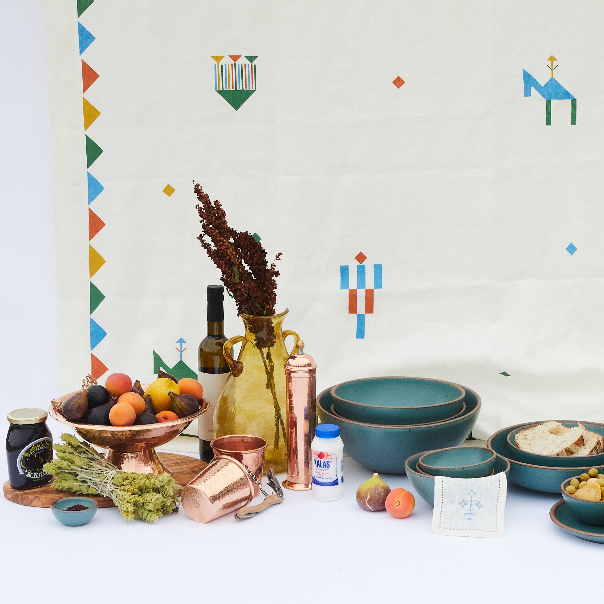 White tablecloth with festival images hanging behind a feast