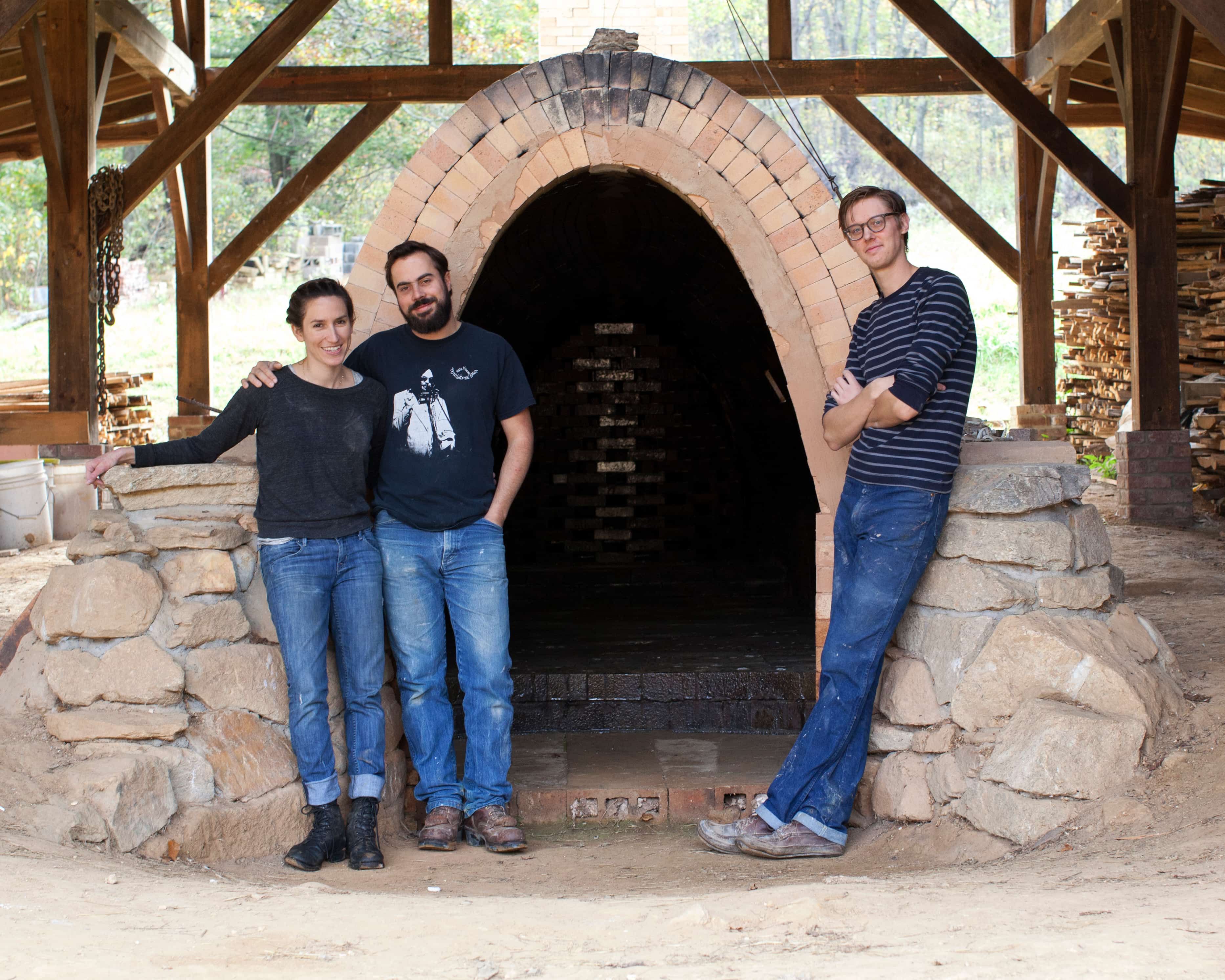 East Fork co-founders Connie Matisse, Alex Matisse and John Vigeland standing in front of the original wood-fired kiln