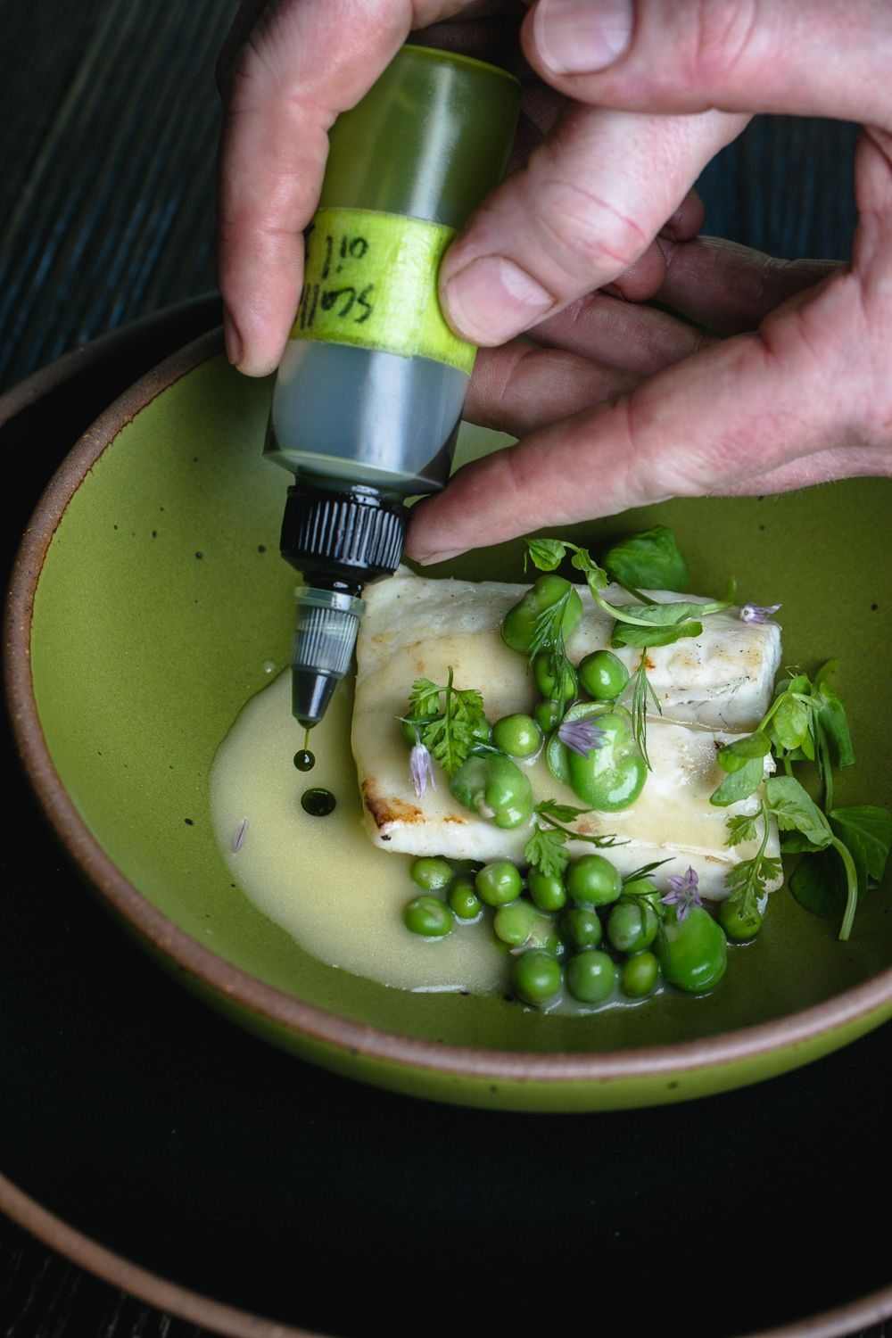 Wild turbot and spring peas in an East Fork everyday bowl in Fiddlehead green.