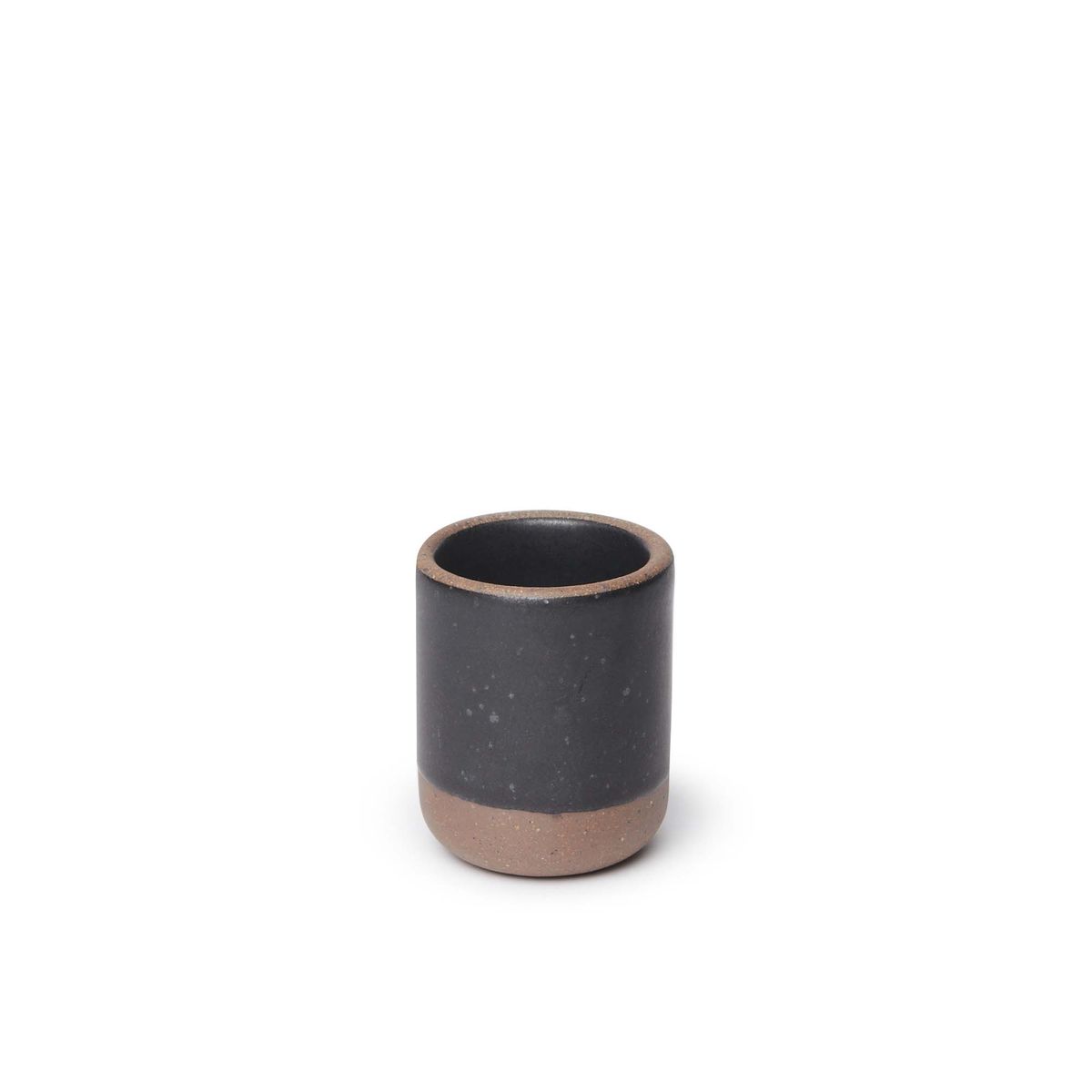 A small, short ceramic mug cup in a graphite black color featuring iron speckles and unglazed rim and bottom base.