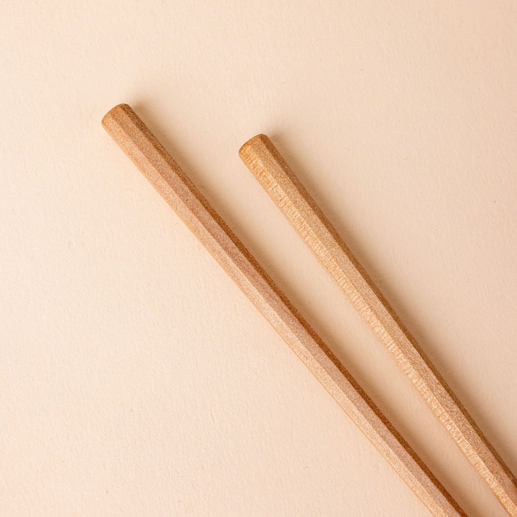 Hexagonal tip of simple pair of light wood chopsticks