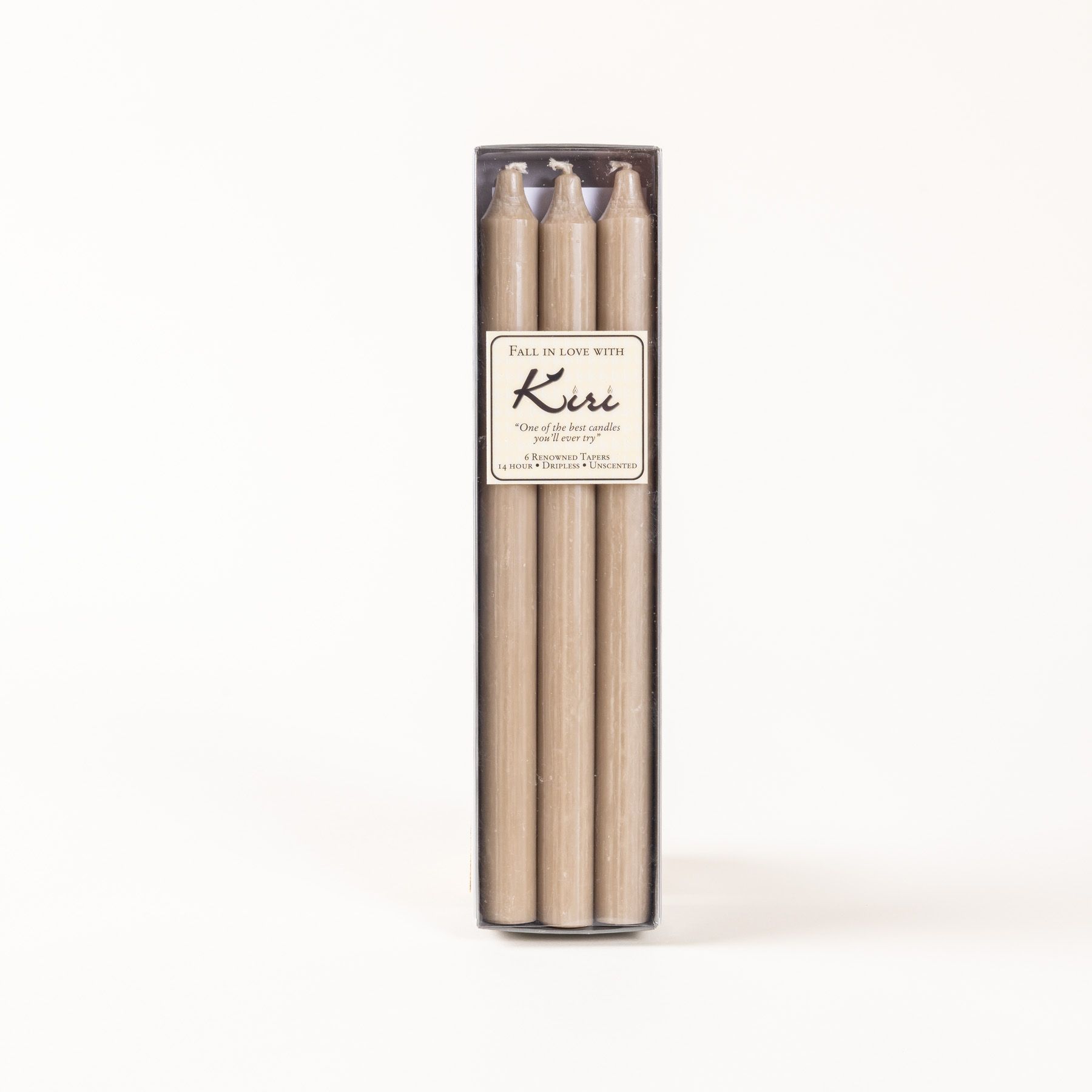 A narrow box of beige taper candles with a cream label.