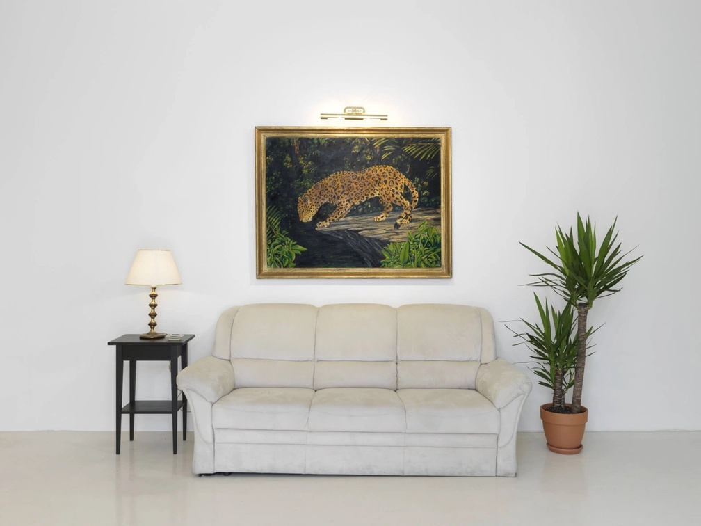 Slide 1/2: William Leavitt, Set for The Tropics with Jaguar (from “The Tropics”), 1974, mixed media (οil on canvas, couch, side table, plant, lamp, picture light, ashtray). Installation view. Courtesy of the artist and Greene Naftali Gallery, New York.

