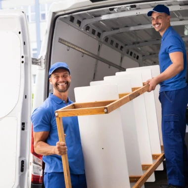 tradesmen putting things in truck