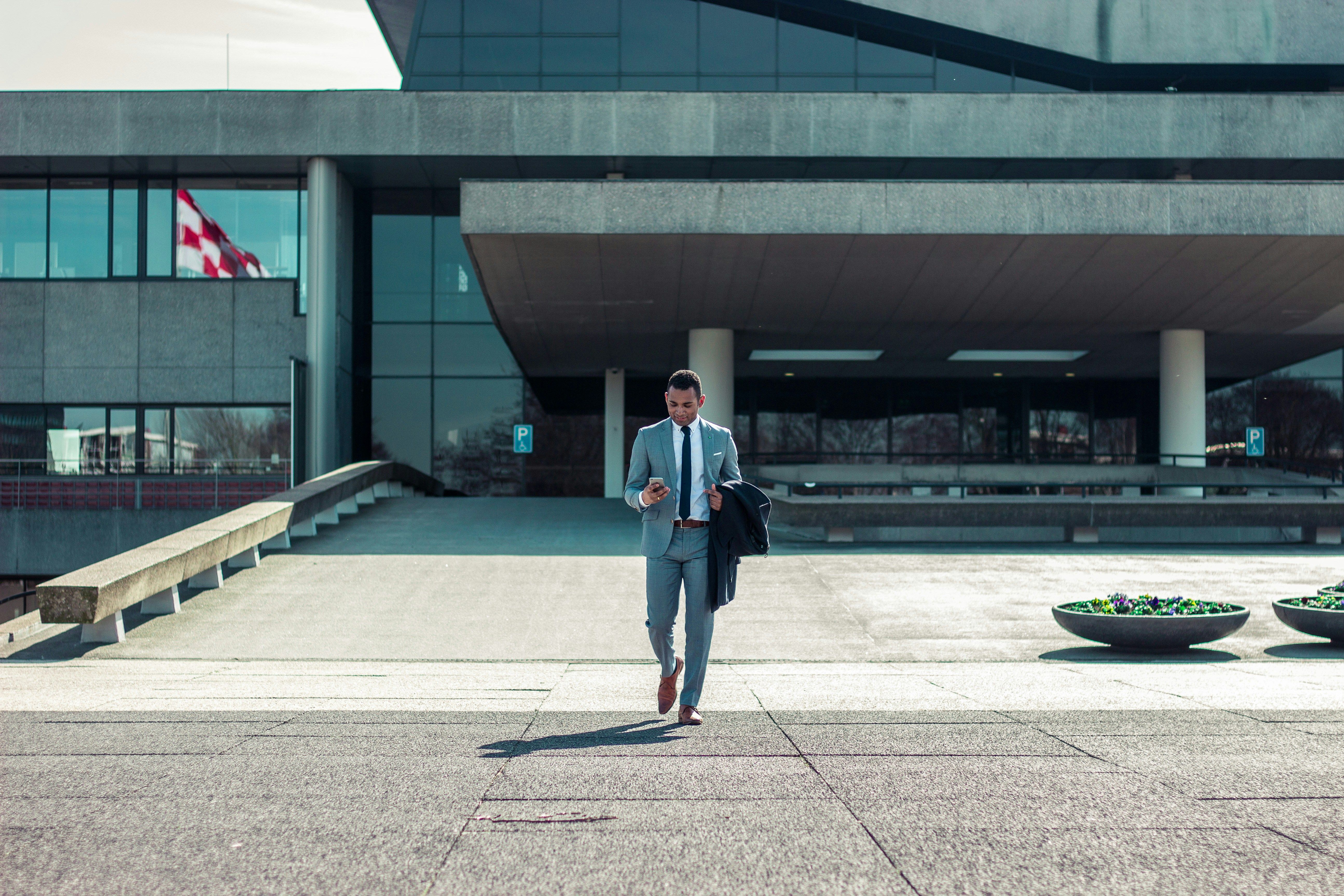 enterpreneur walking outside building
