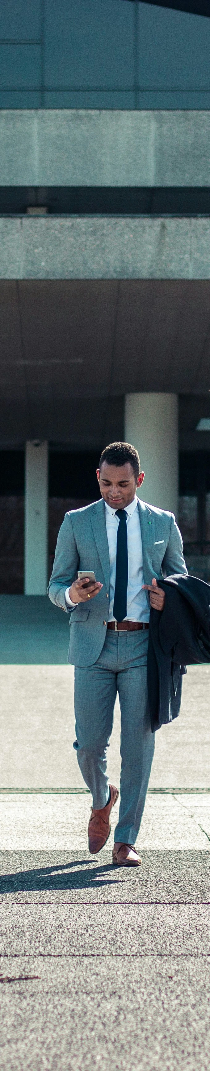 enterpreneur walking outside building
