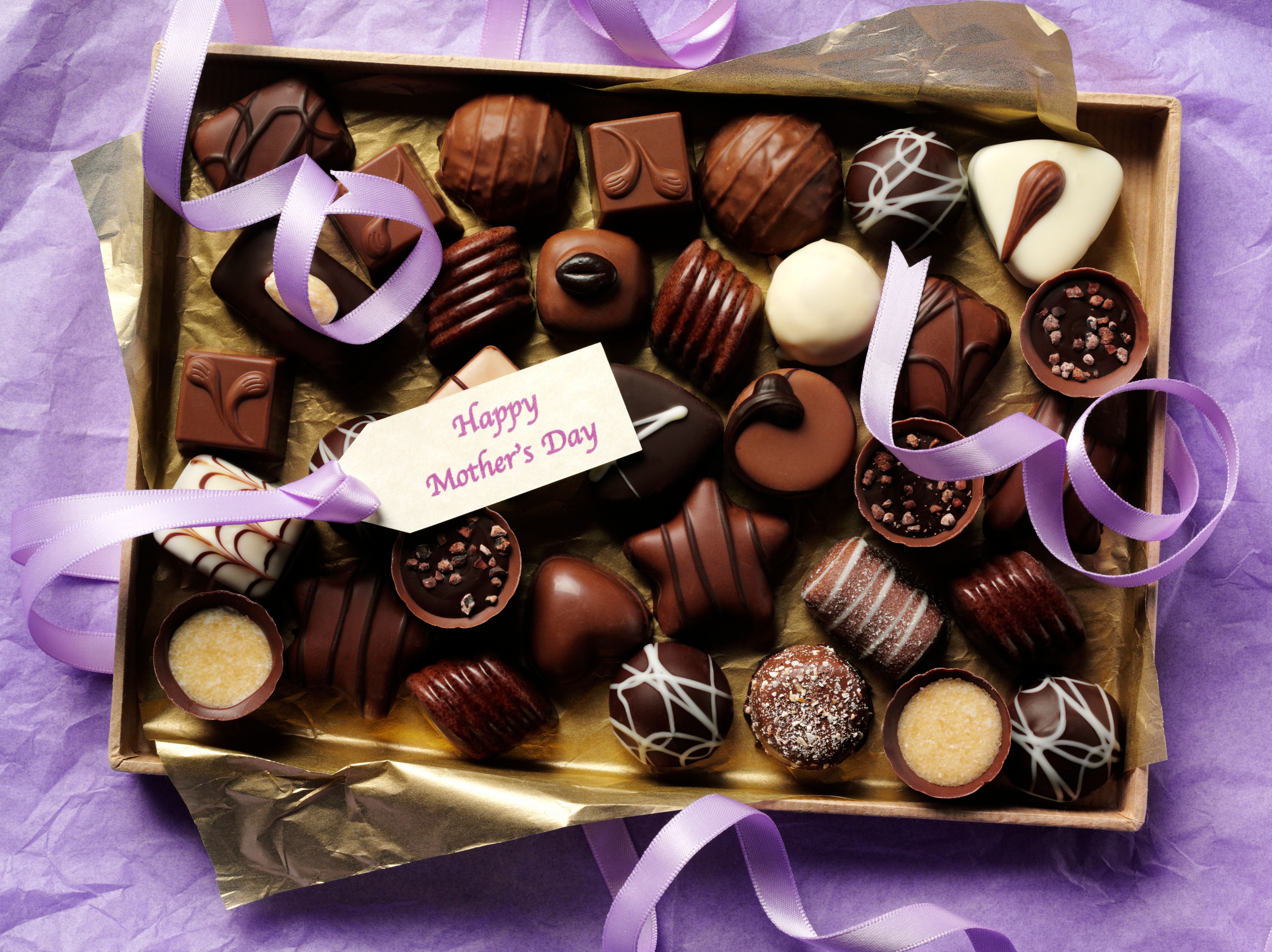 box of chocolates on purple background happy mother's day