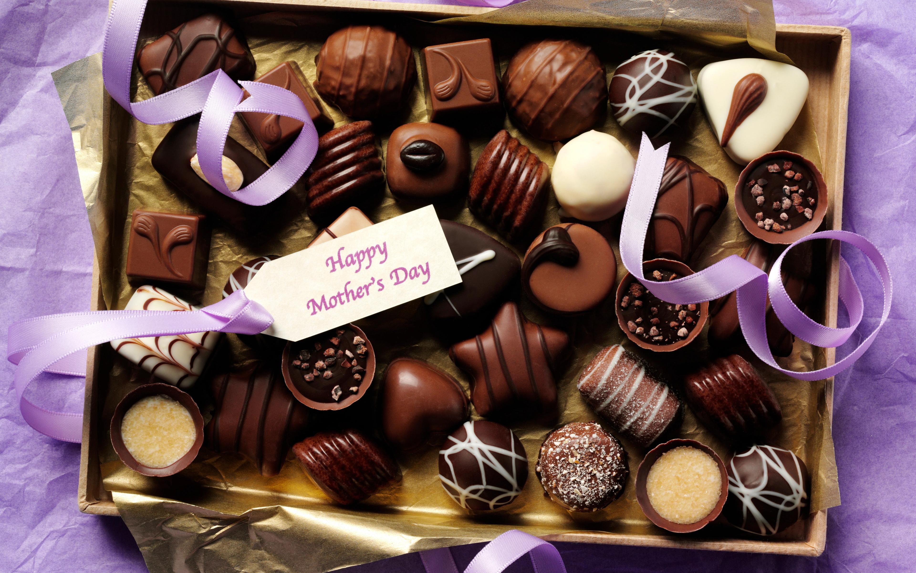 box of chocolates on purple background happy mother's day