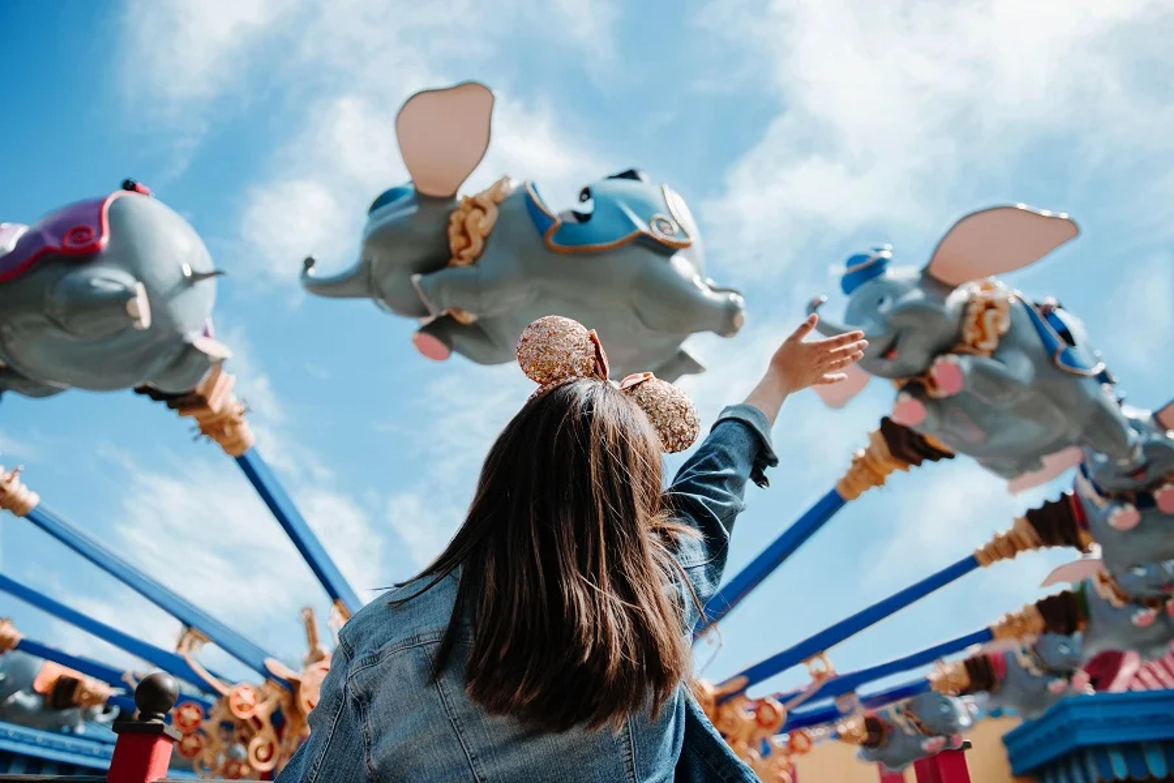 Woman in front of Disney ride