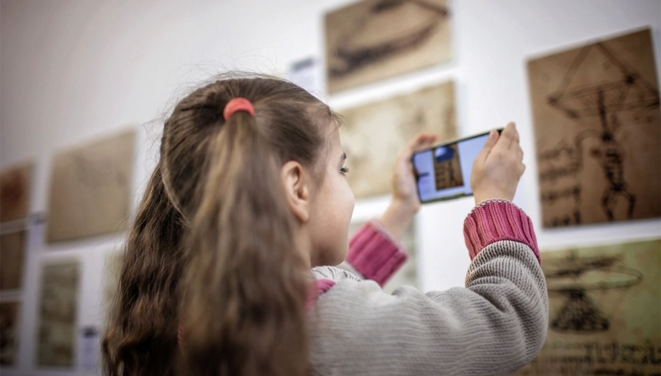A child taking photos in an art studio.