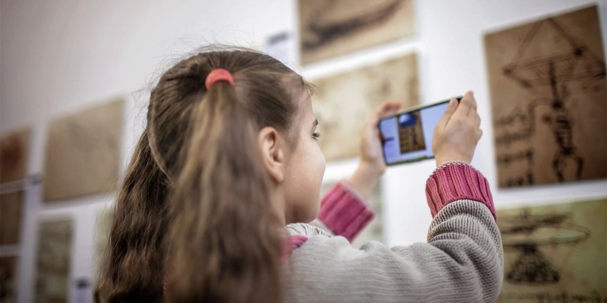A child taking photos in an art studio.