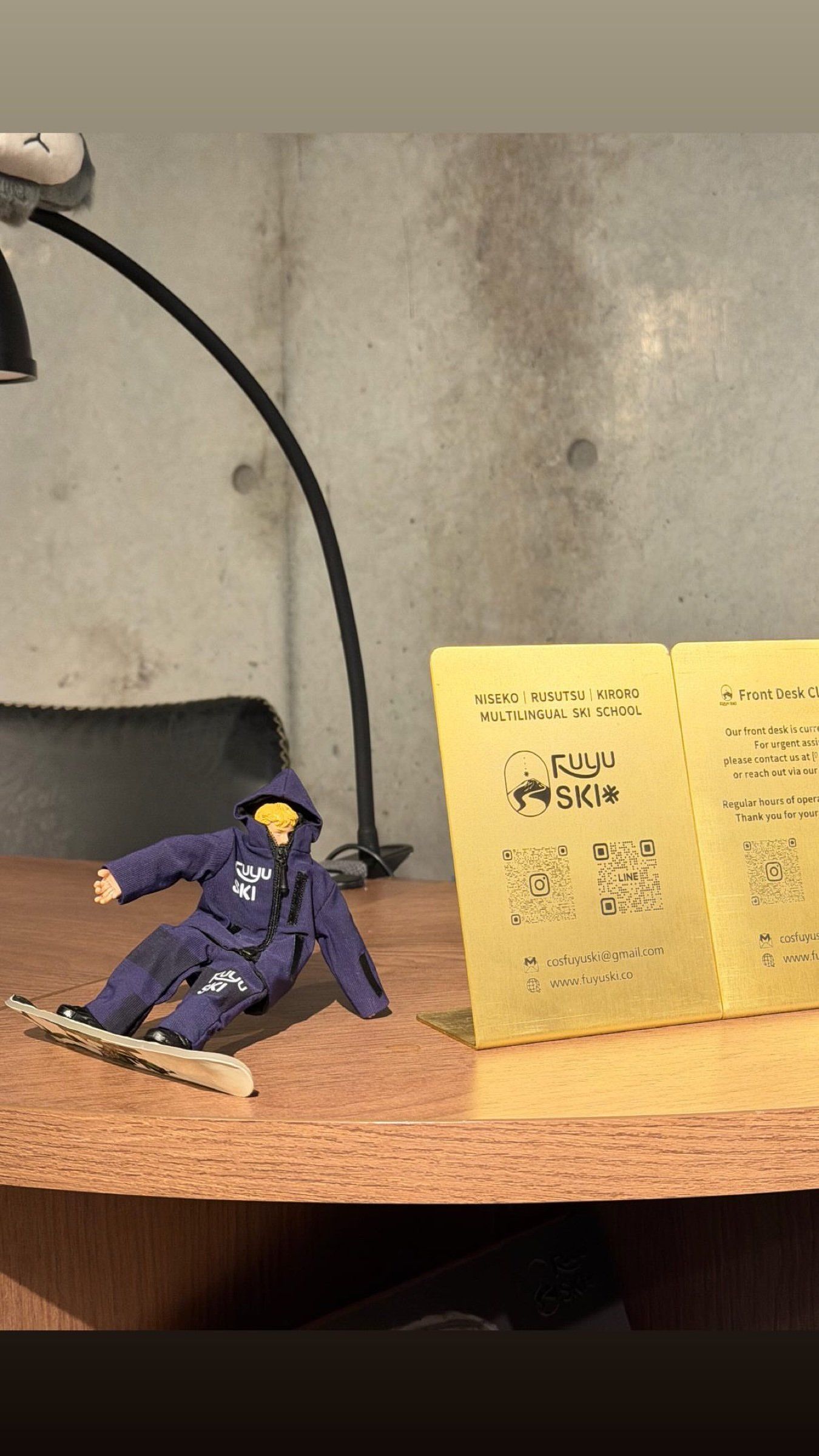 A FUYU skier figurine and contact sign on the front desk