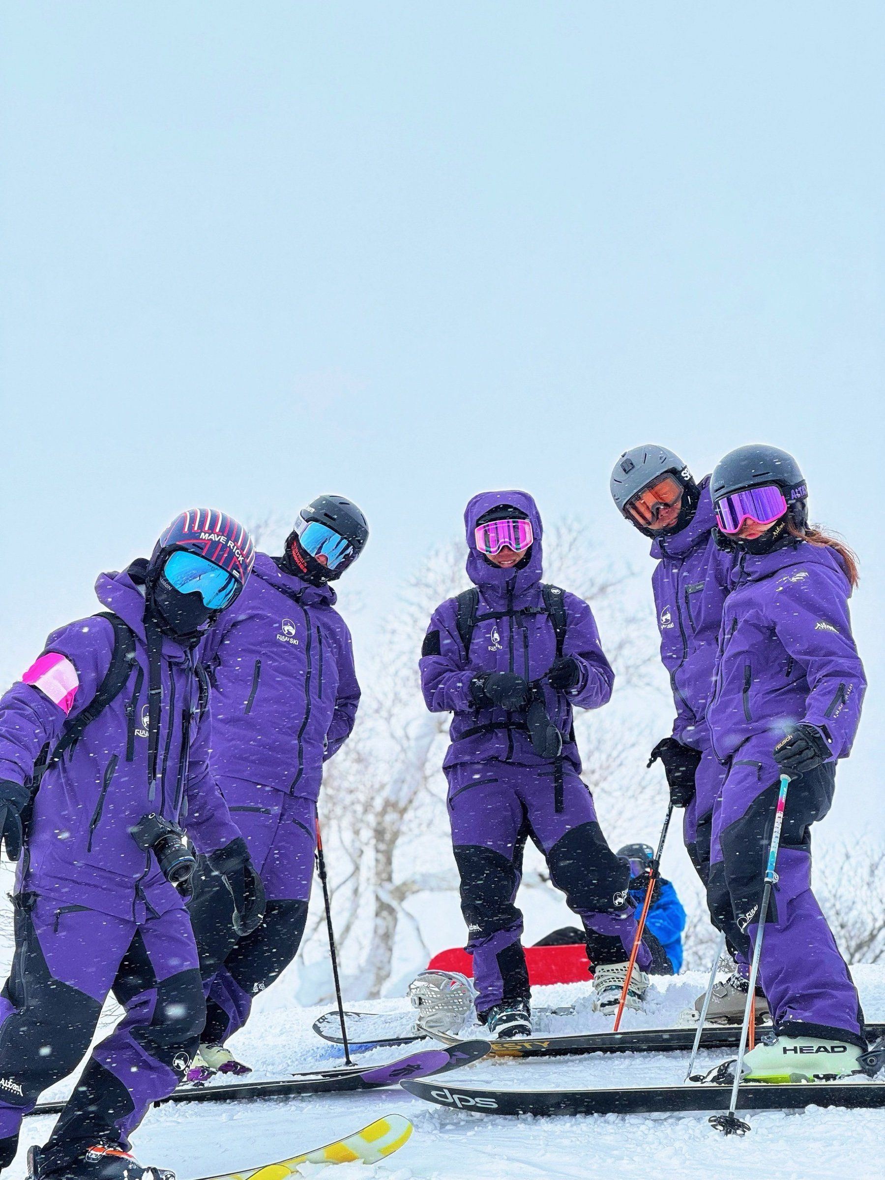 FUYU coaches in purple uniforms at the top of the slopes