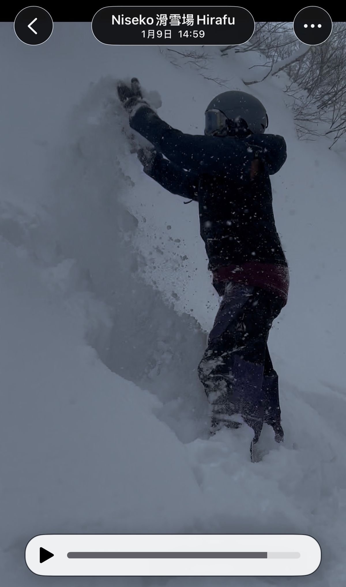A rider waist-deep in powder, pushing up with both hands. The capture stamp reads Niseko Hirafu, 9 January, 14:59