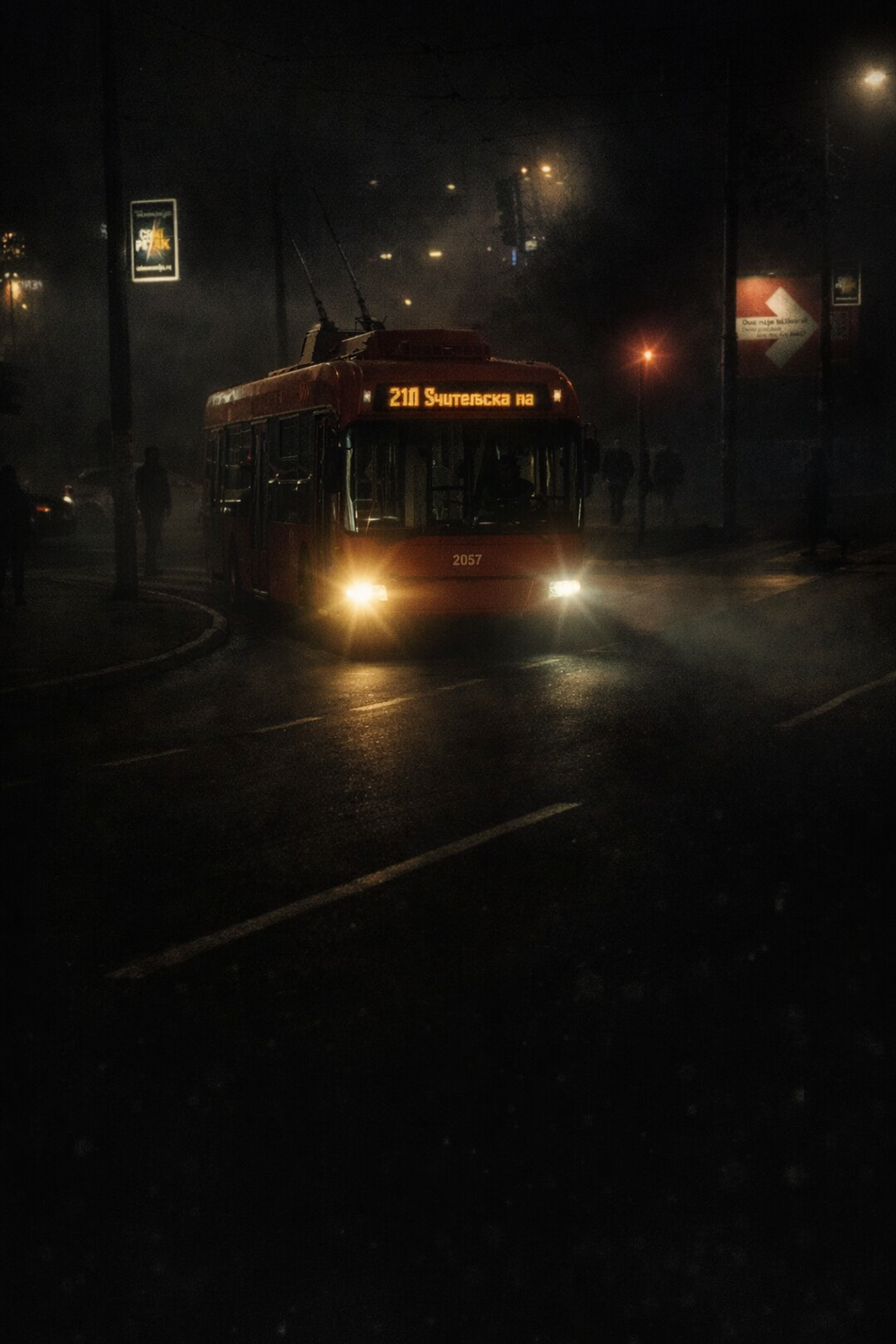 Atmospheric night photograph of a Belgrade trolleybus with glowing headlights emerging through heavy fog on a dark city street.