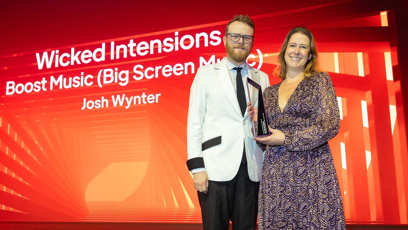 Big Screen Music's Olivia Dixon with Huw Stephens at the Production Music Awards 2023, collecting the award for Best Score