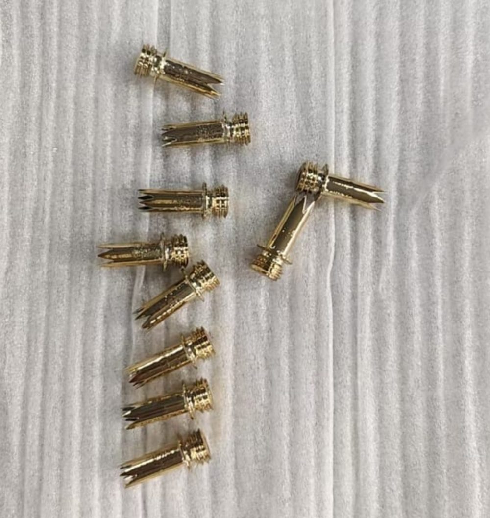 Finished custom threaded metal components arranged for inspection