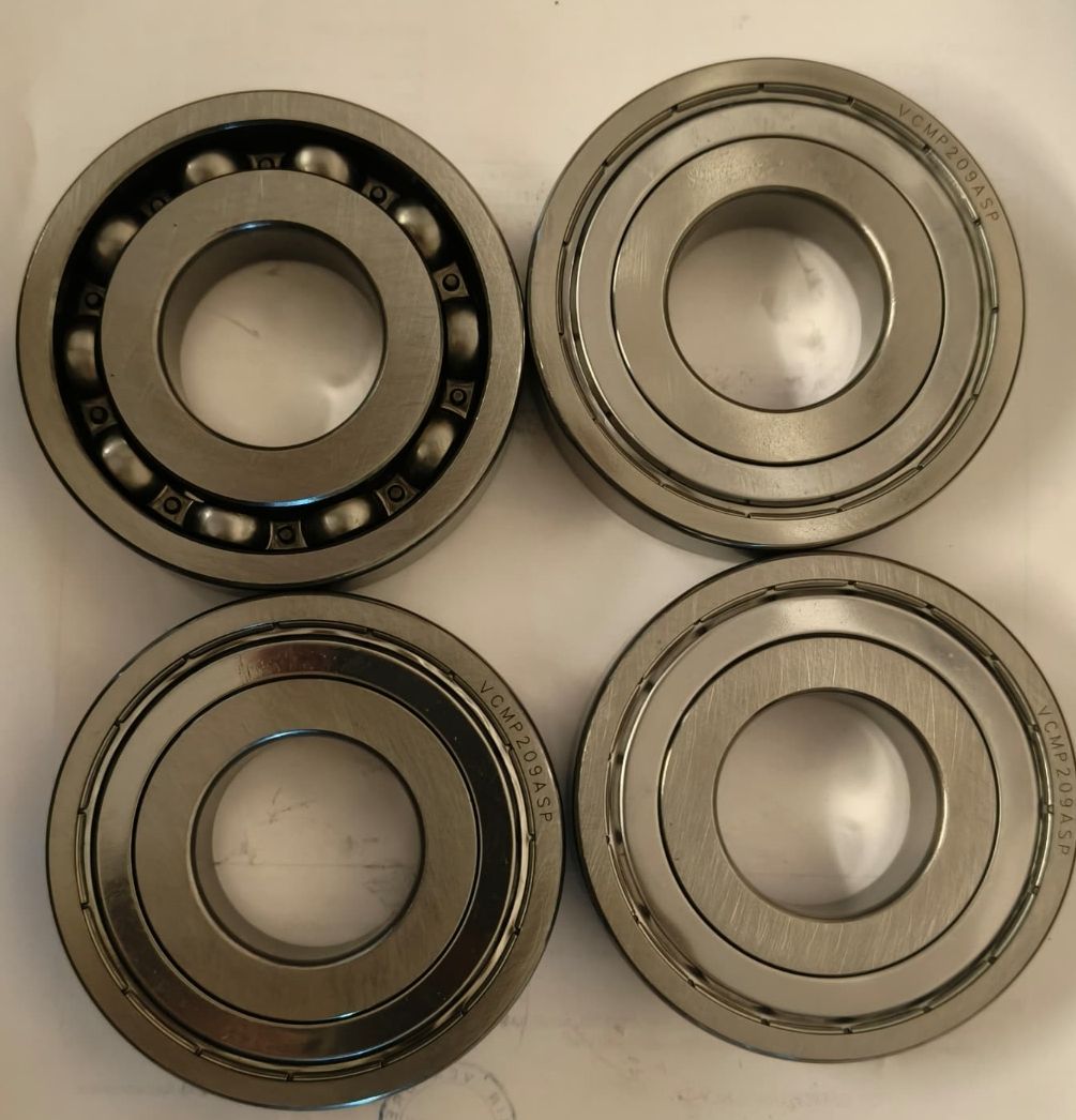 Four Barden VCMP209ASP bearings showing open and shielded faces