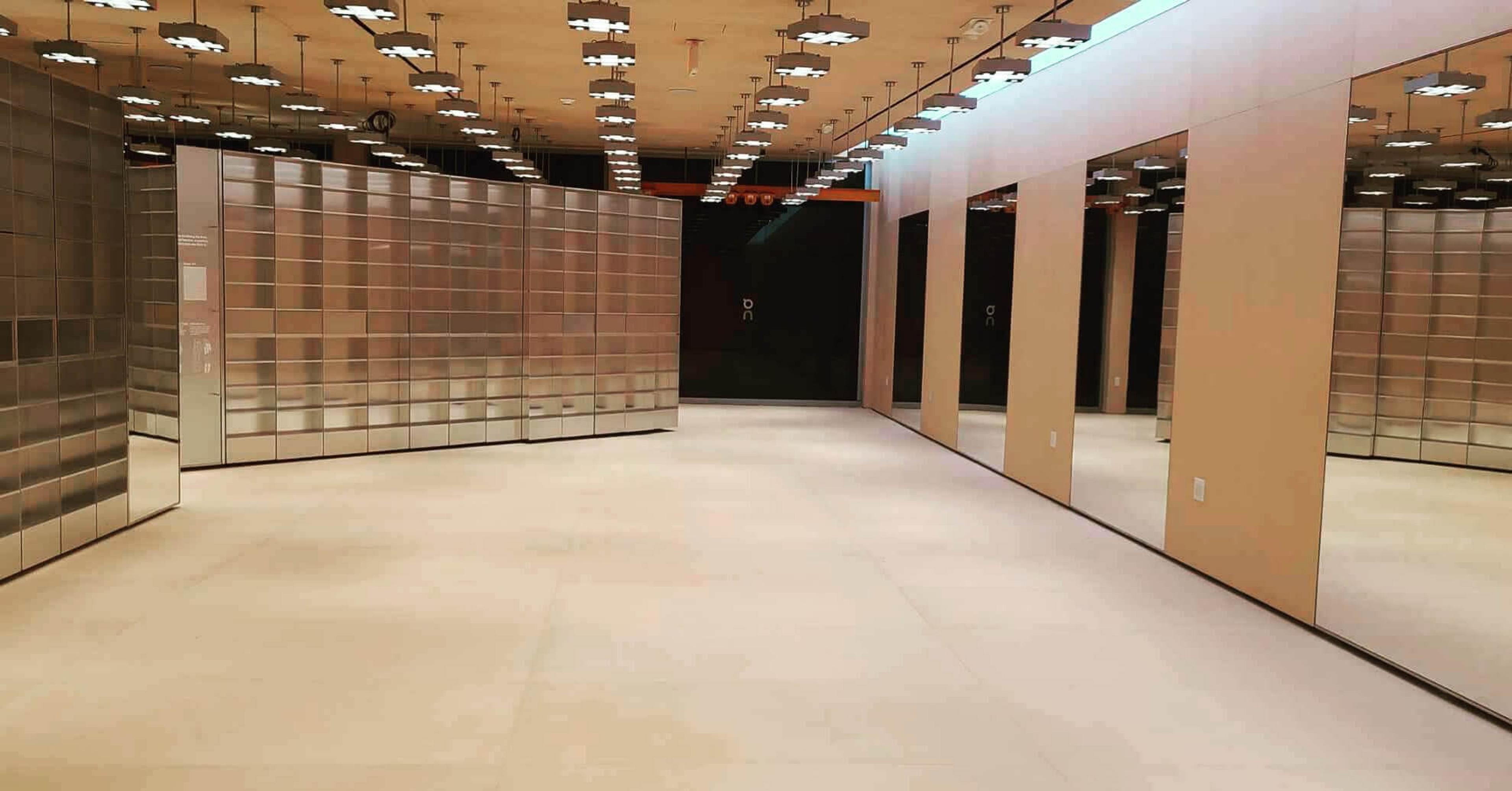 Empty retail space with a smooth self-leveled concrete floor and mirrored walls