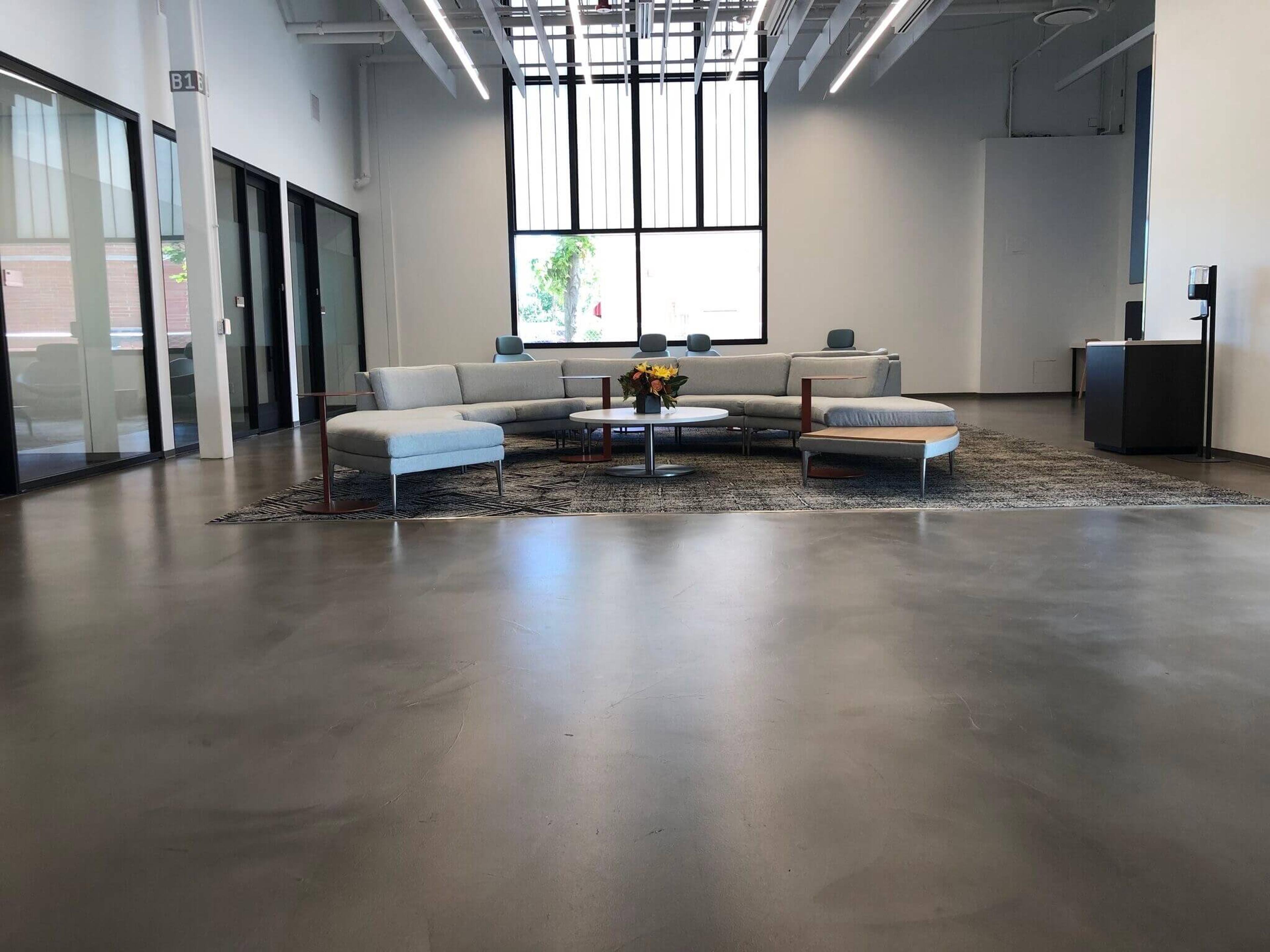 Microcement floor in a bright modern office lounge