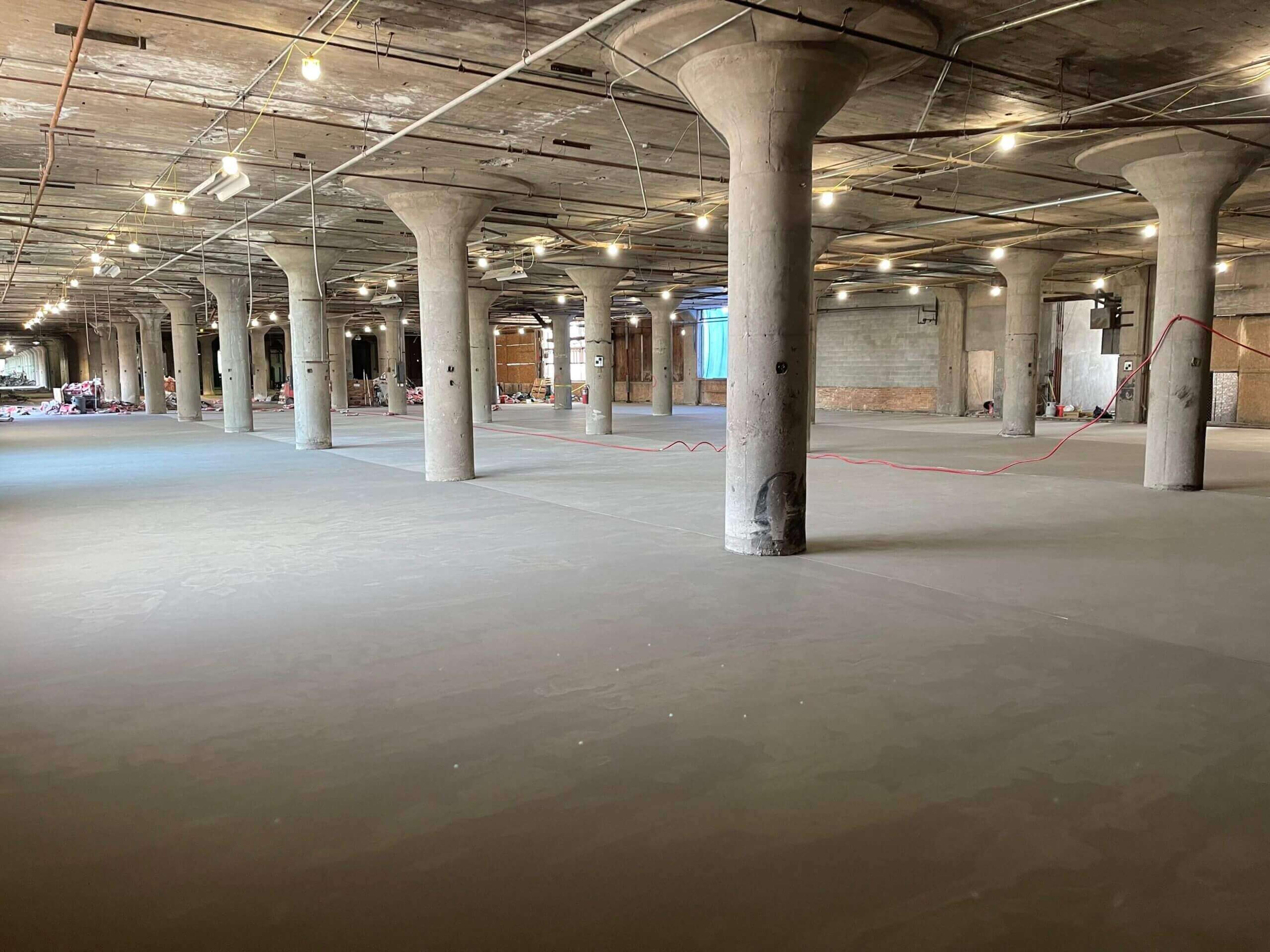Leveled concrete floor in a large industrial building with mushroom columns