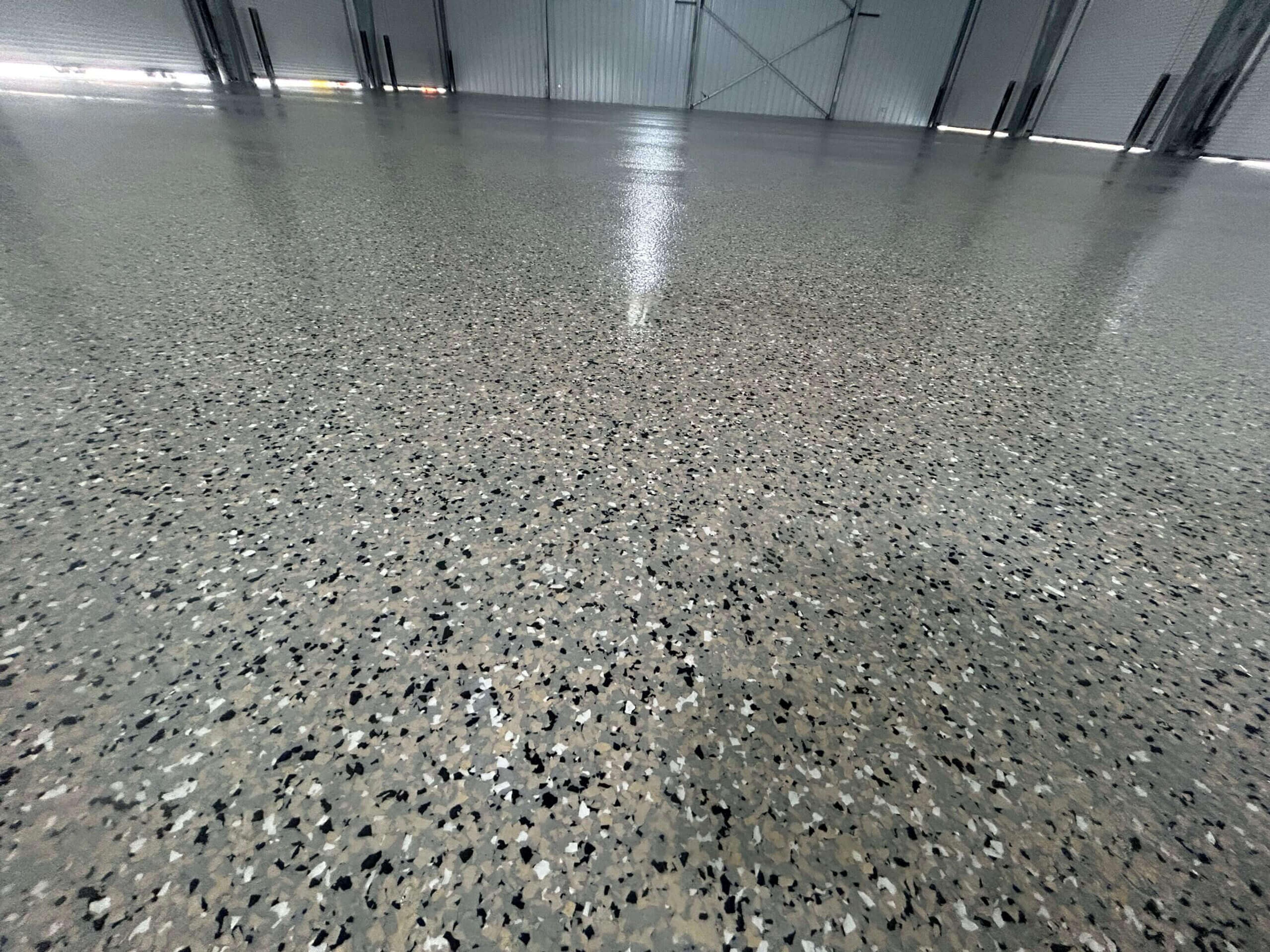 Close-up of a glossy gray flake epoxy floor