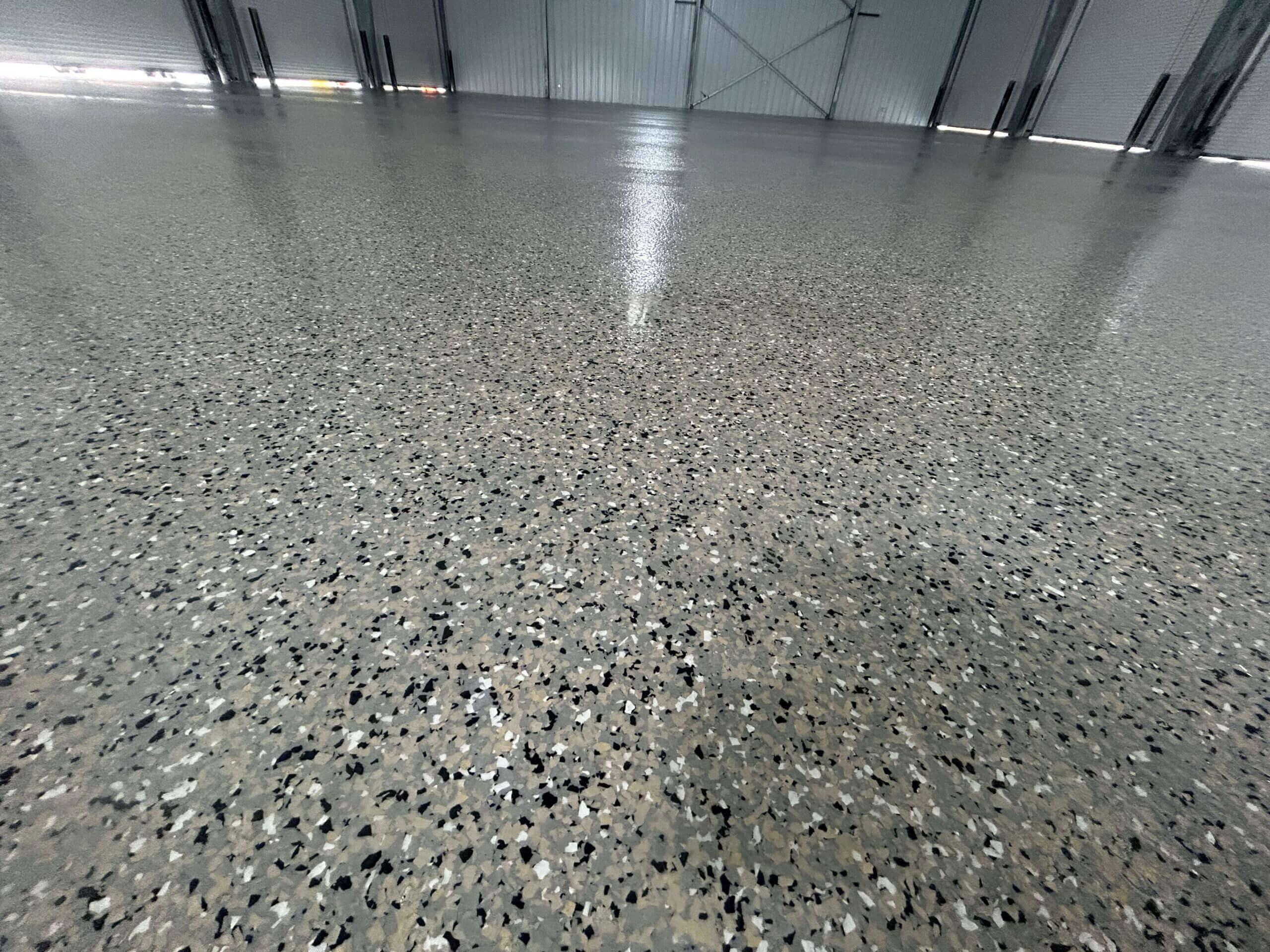 Close-up of a glossy gray flake epoxy floor