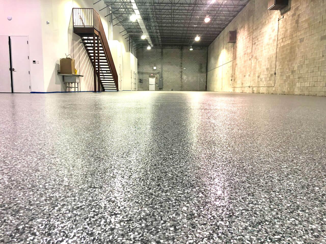 Glossy gray flake epoxy floor in a warehouse