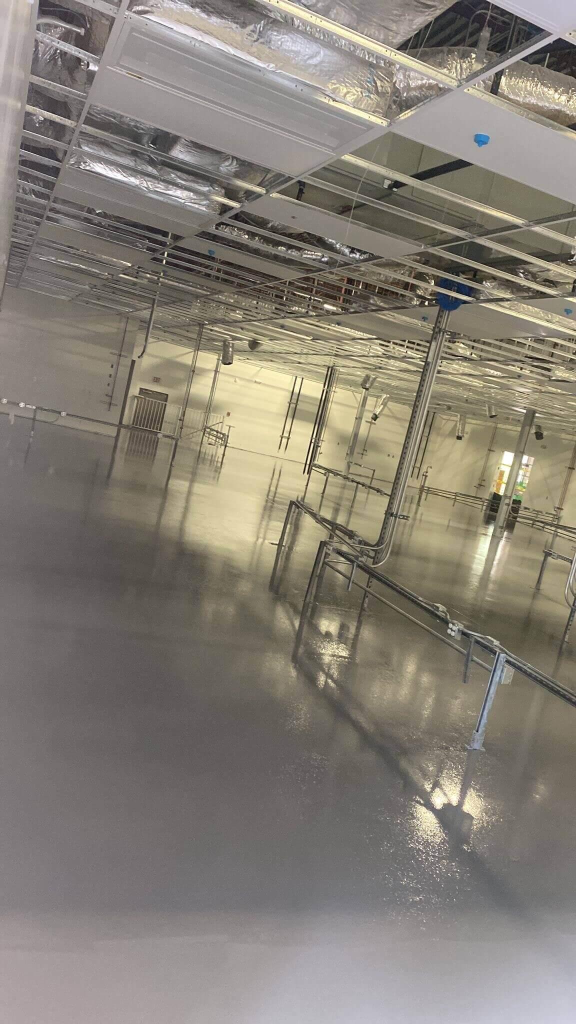 Glossy seamless floor in a commercial kitchen with stainless steel equipment